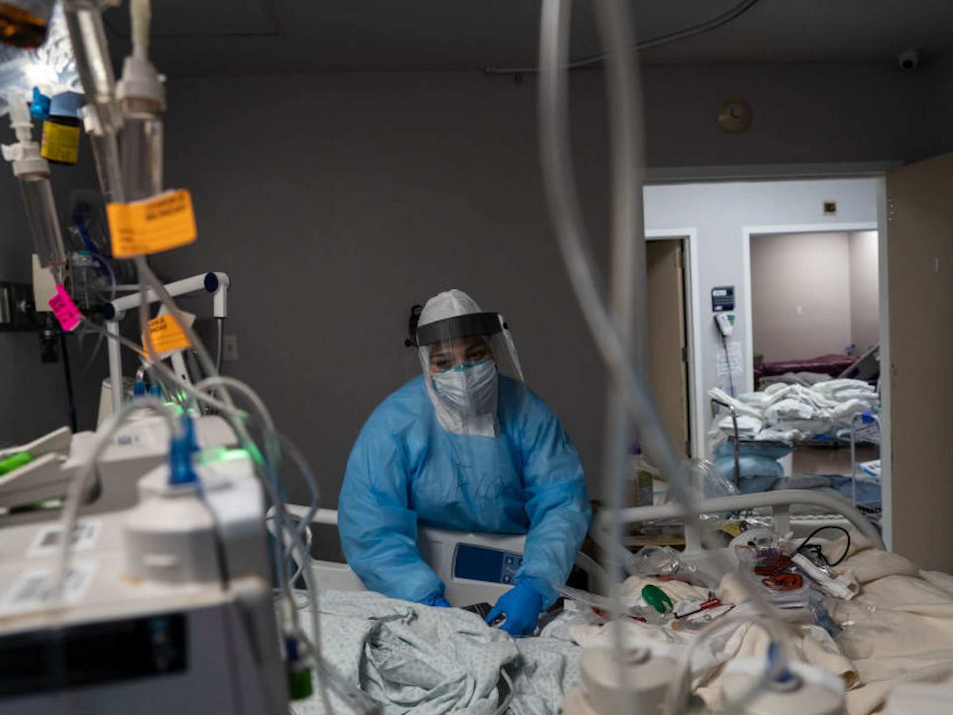 A health care worker treats a COVID-19 patient at the ICU at United Memorial Medical Center in Houston, Texas. Twenty-two percent of hospitals in Texas reported critical staffing shortages this week in new federal data.