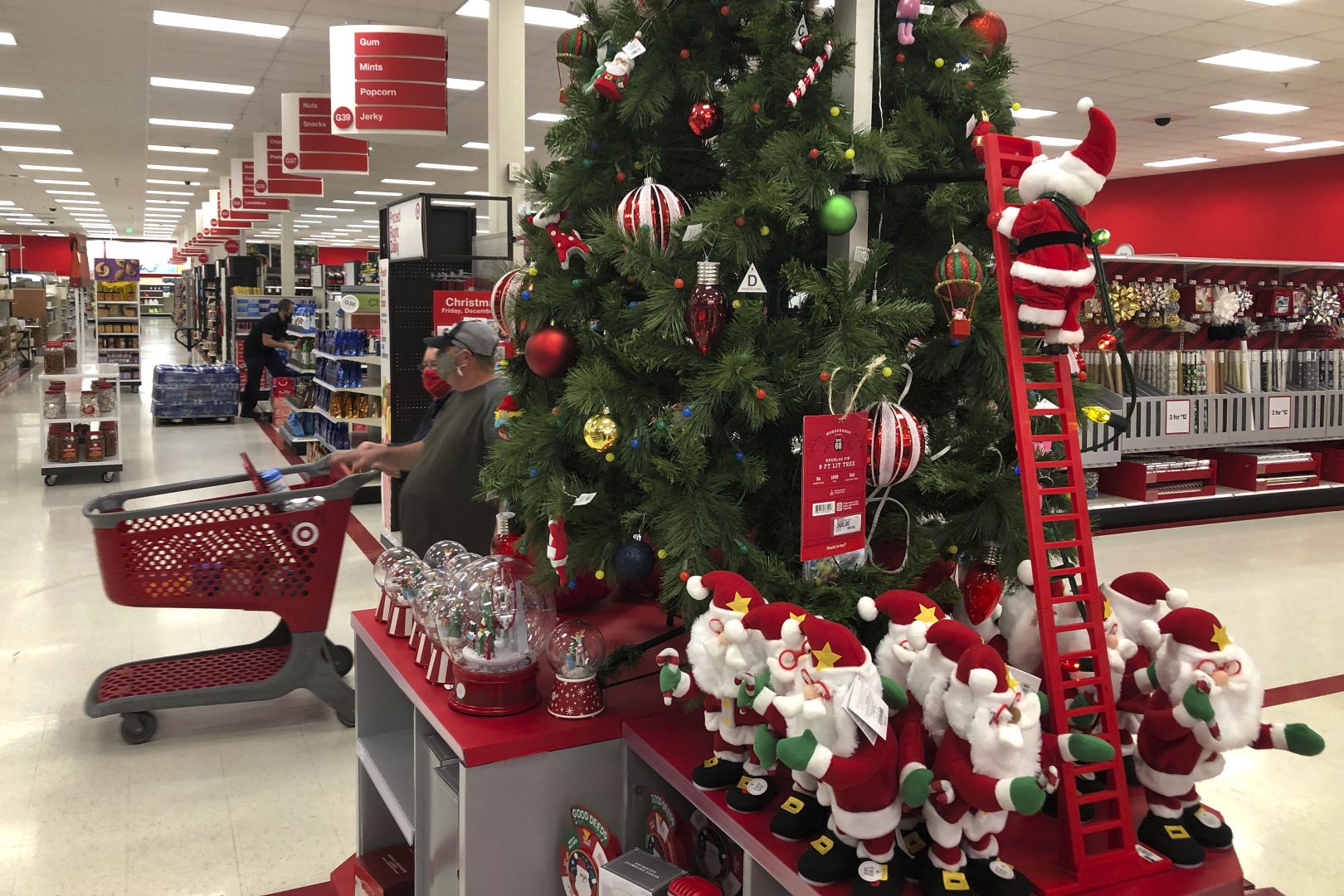 Shoppers walk past a display of Christmas decorations at a Target store, Sunday, Nov. 8, 2020, in Marlborough, Mass. 
