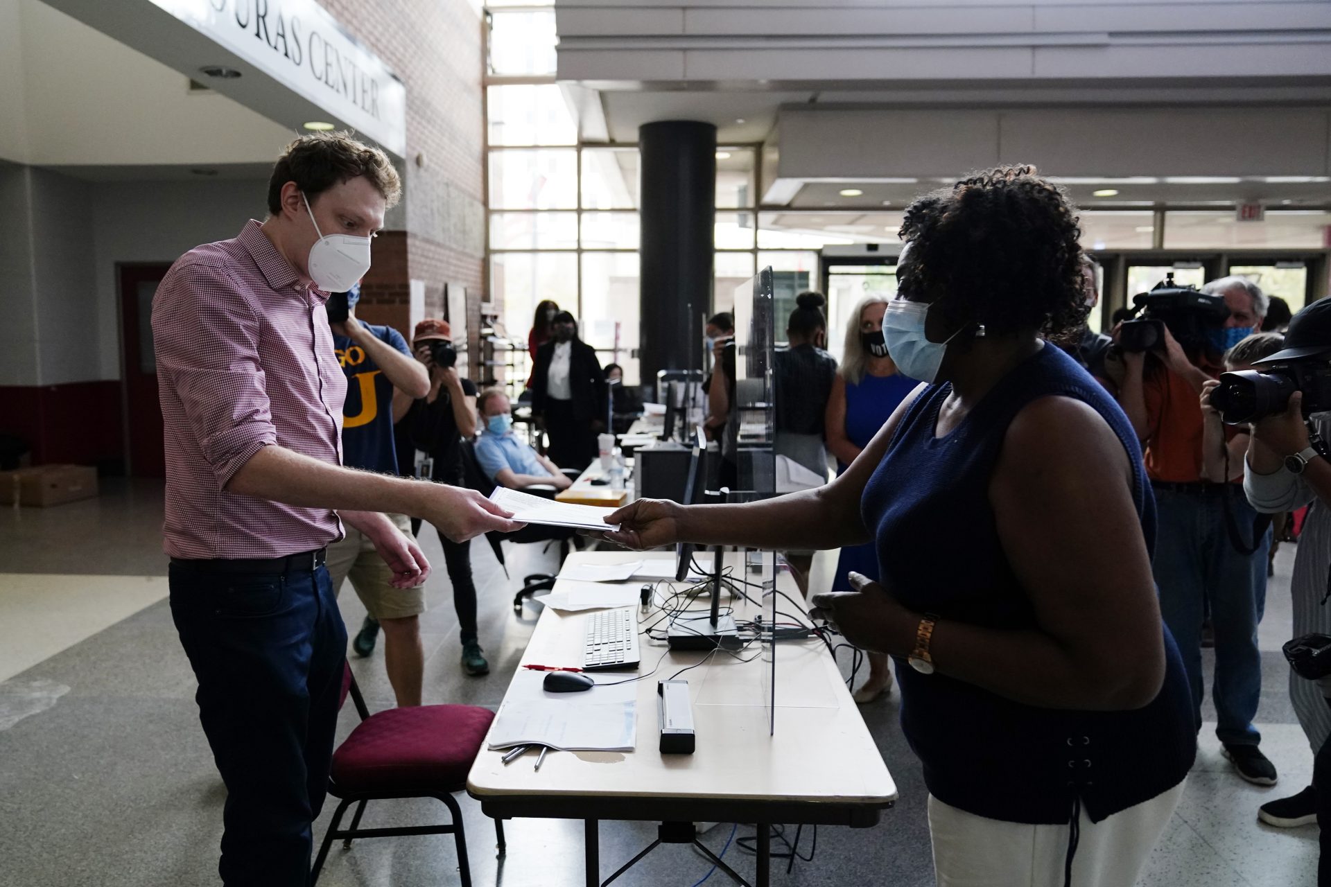 Philadelphia resident Priscilla Bennett receives her mail-in ballot at the opening of a satellite election office at Temple University's Liacouras Center, on Sept. 29, 2020, in Philadelphia. Pennsylvania is one of this year's most hotly contested battleground states and also is facing a flurry of lawsuits, complaints and partisan finger-pointing over its election procedures and systems.