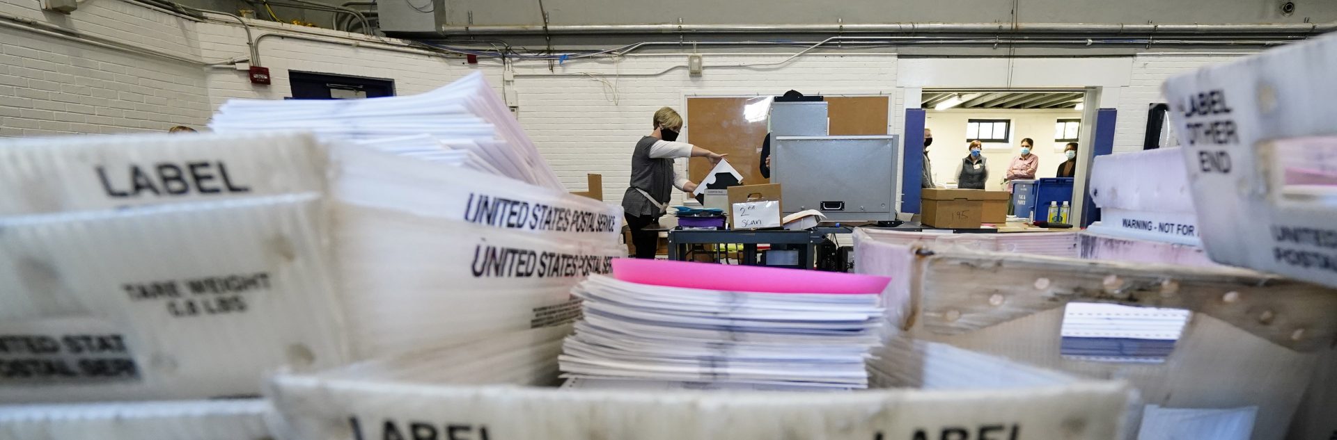 Chester County election workers scan mail-in and absentee ballots for the 2020 general election in the United States at West Chester University, Wednesday, Nov. 4, 2020, in West Chester.