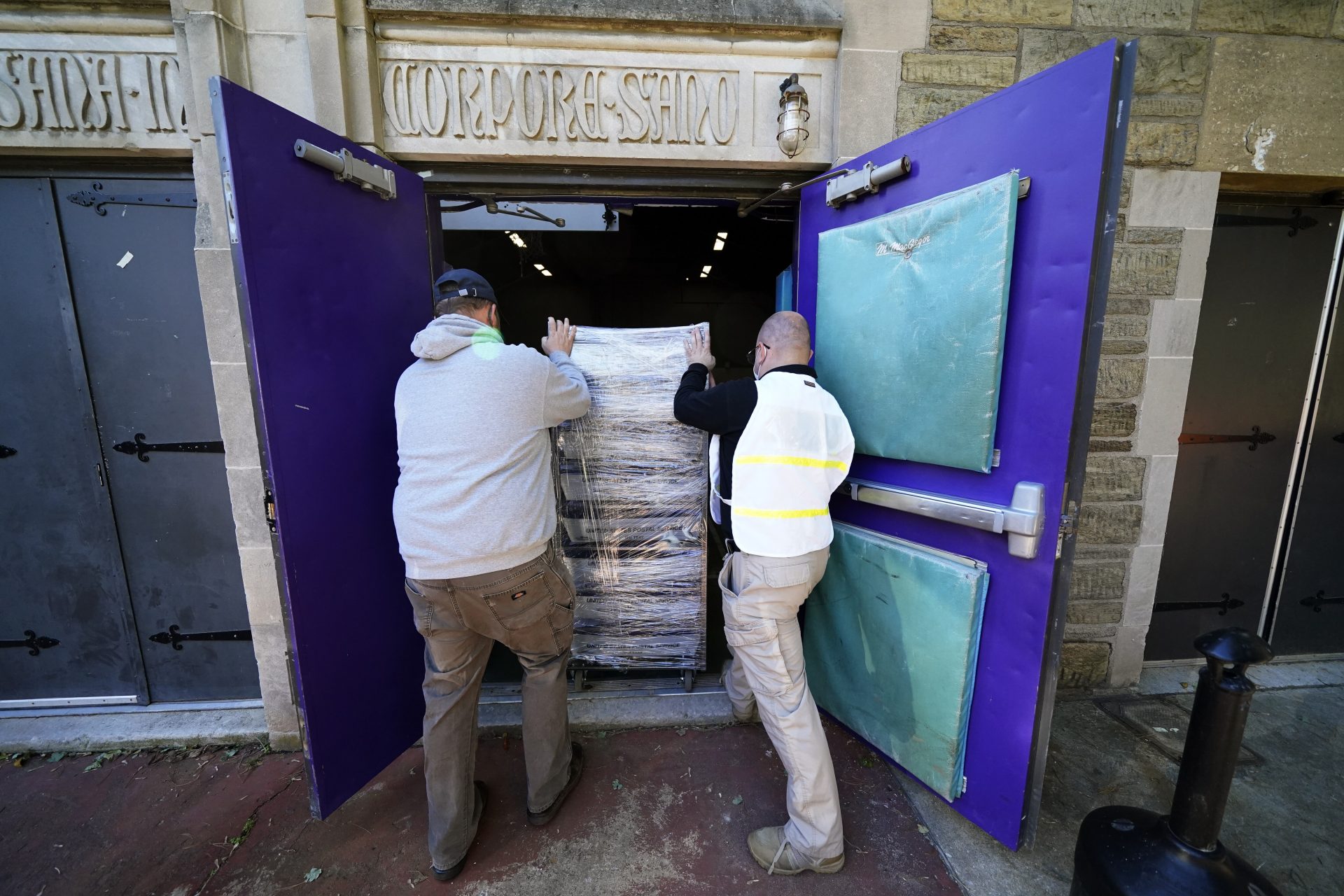 Chester County, Pa., workers transport mail-in and absentee ballots to be processed at West Chester University, Wednesday, Nov. 4, 2020, in West Chester.