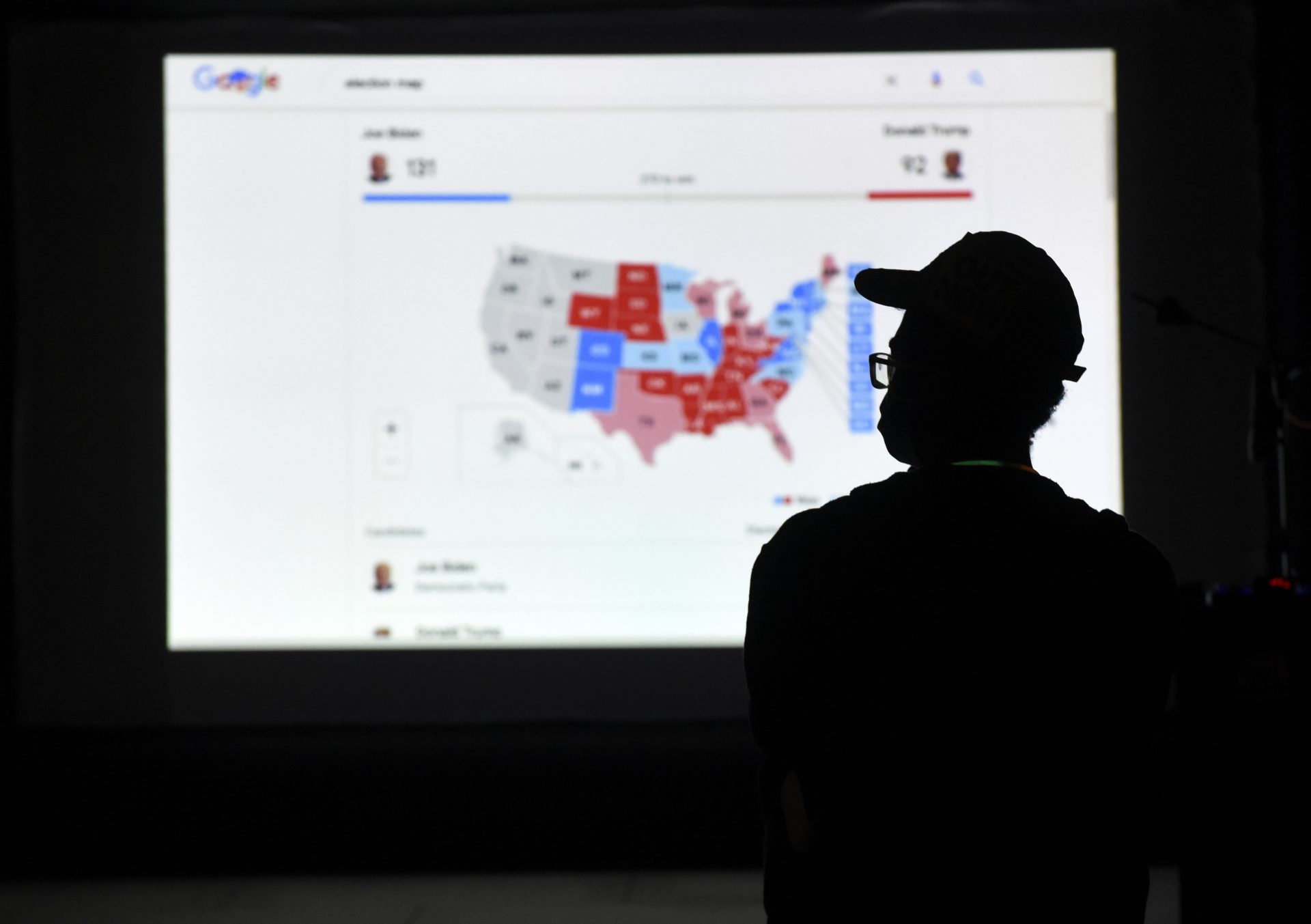 A man watches results come in on a screen set up at an election night gathering at Independence Mall , Tuesday, Nov. 3, 2020, in Philadelphia.