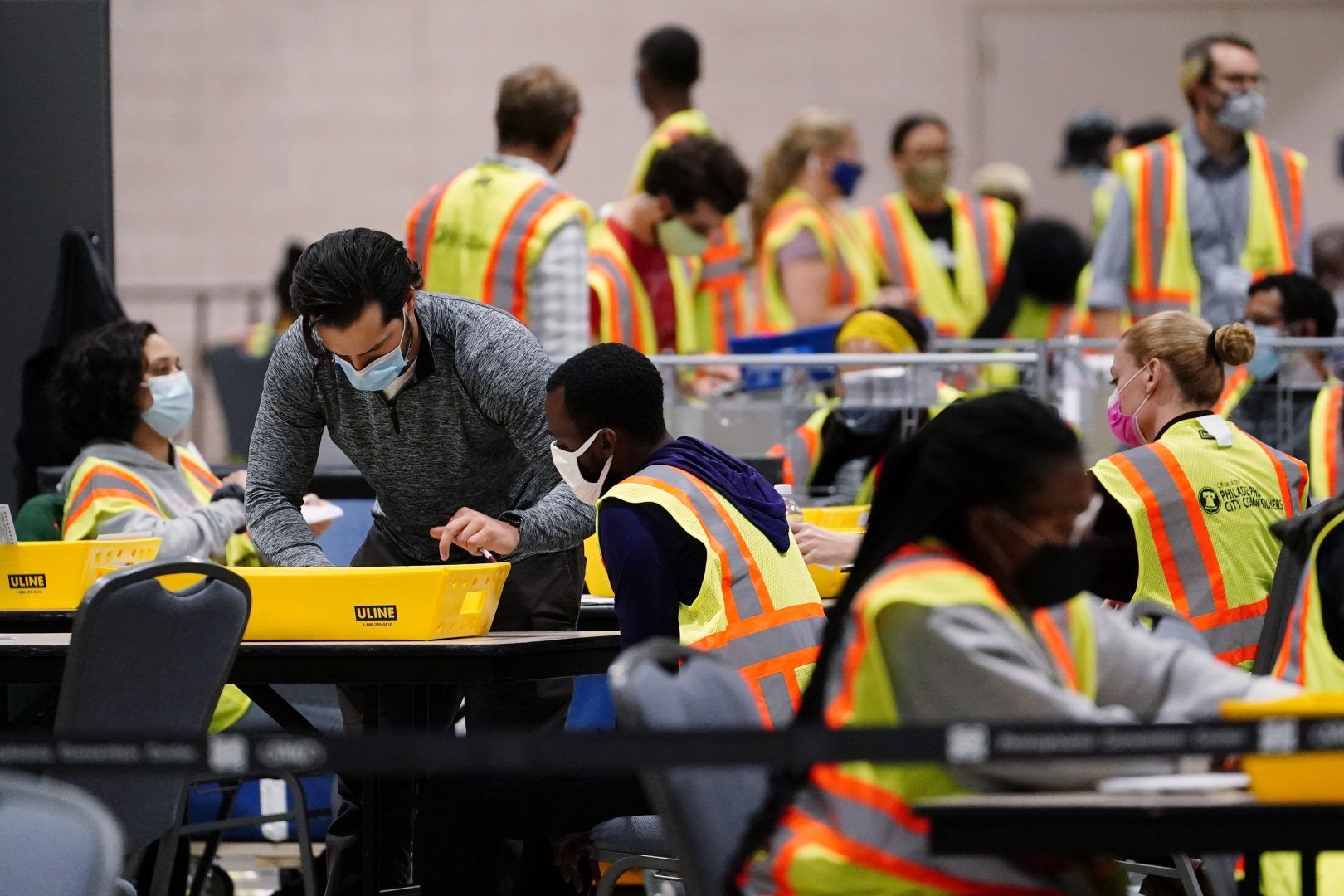 Philadelphia election workers process mail-in and absentee ballots for the general election, at the Pennsylvania Convention Center, Tuesday, Nov. 3, 2020, in Philadelphia. 