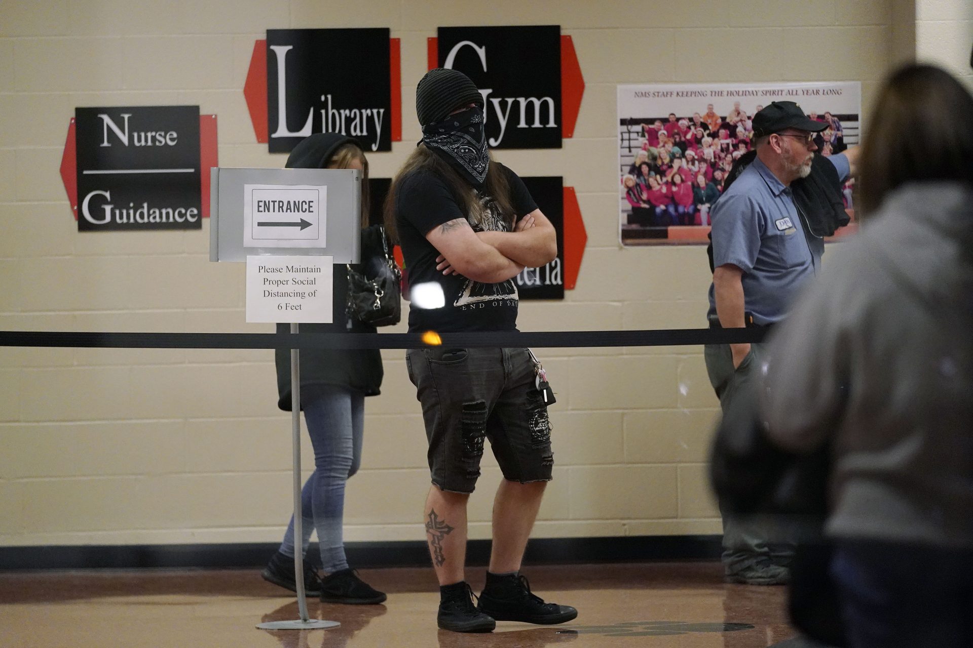 The final two people stand in line to vote after a long wait at a polling station at Northeastern Middle School, Tuesday, Nov. 3, 2020, in Mount Wolf, Pa.