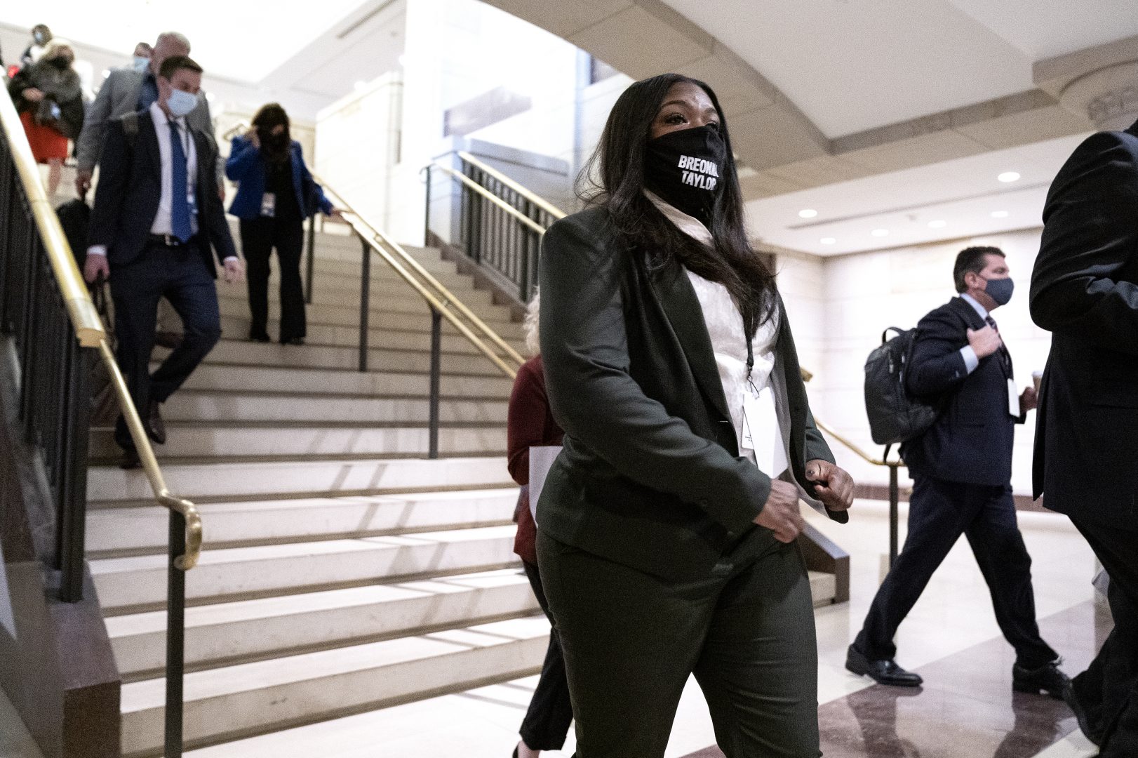 Representative-elect Cori Bush, a Democrat from Missouri, center, wears a protective mask while arriving to a new member briefing at the U.S. Capitol in Washington, D.C., U.S., on Friday, Nov. 13, 2020. With the pandemic raging the circumstances dictated that this orientation for the Republicans and Democrats elected last week bore little resemblance to previous sessions of introductions and briefings marked by plenty of glad-handing.
