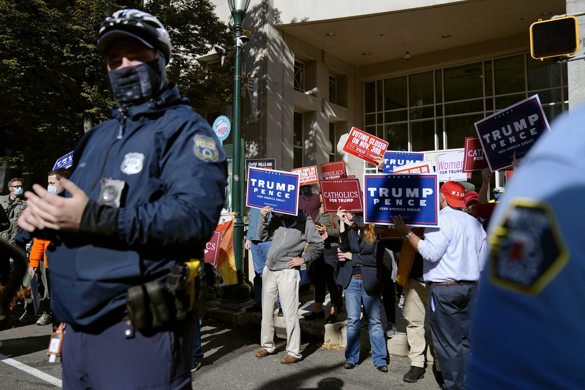 Police officers stand watch as protesters demonstrate outside the Pennsylvania Convention Center where votes are being counted, Thursday, Nov. 5, 2020, in Philadelphia, following Tuesday's election.