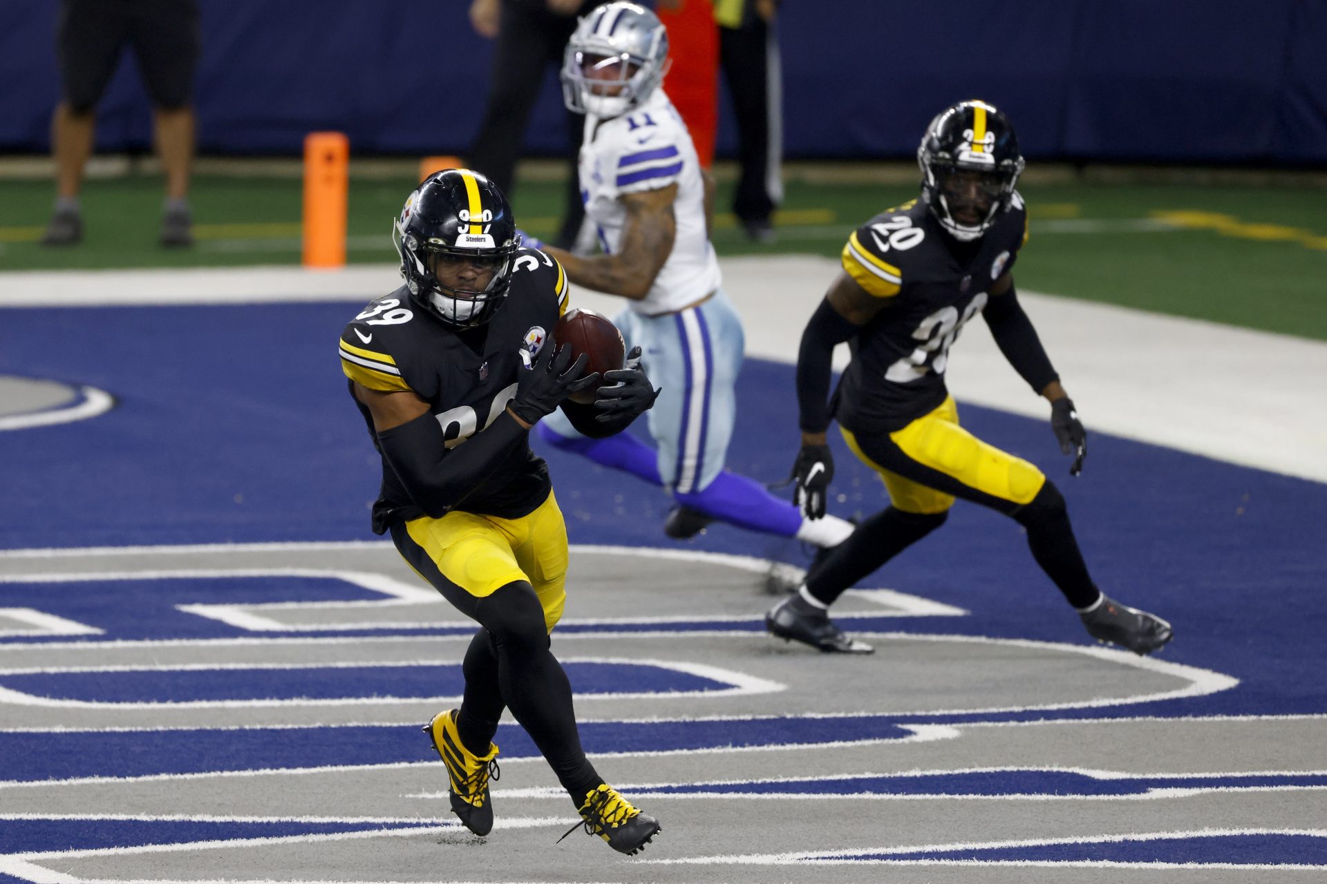 Pittsburgh Steelers safety Minkah Fitzpatrick (39) intercepts a Dallas Cowboys' Garrett Gilbert pass in the end zone as Cameron Sutton (20) and Cowboys wide receiver Cedrick Wilson (11) look on in the second half of an NFL football game in Arlington, Texas, Sunday, Nov. 8, 2020.