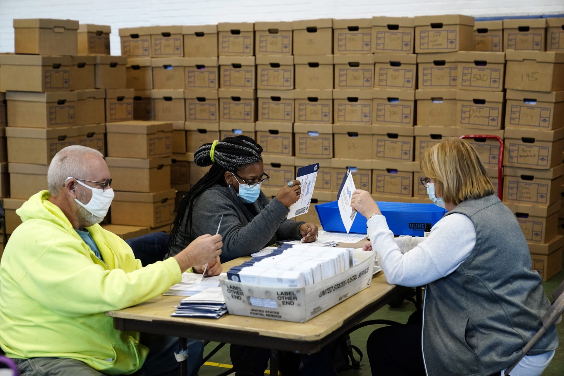 Chester County, Pa., election workers process mail-in and absentee ballots for the 2020 general election in the United States at West Chester University, Wednesday, Nov. 4, 2020, in West Chester., Pa.