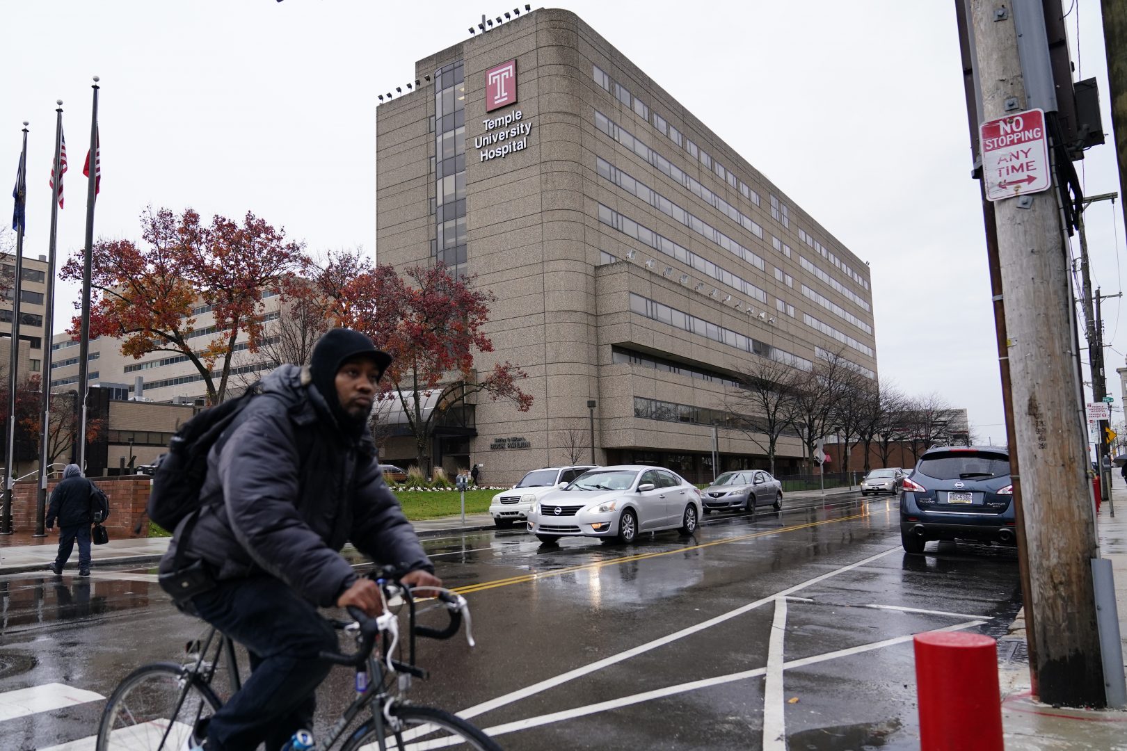 A man rides a bicycle past Temple University Hospital, Friday, Dec. 4, 2020, in Philadelphia.
