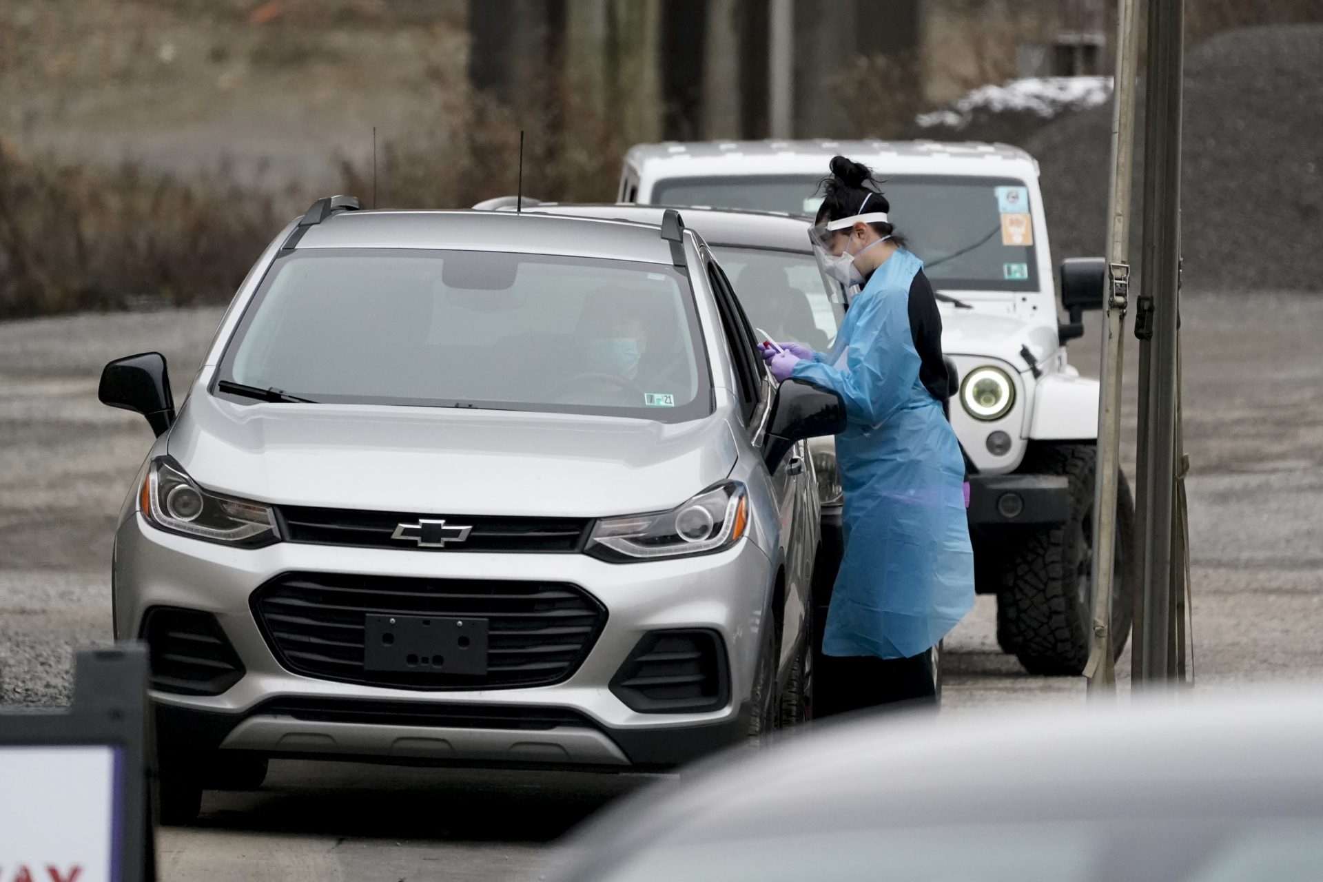 Health care workers start the process for COVID-19 testing at a drive-thru site, Friday, Dec. 4, 2020, in Butler, Pa.