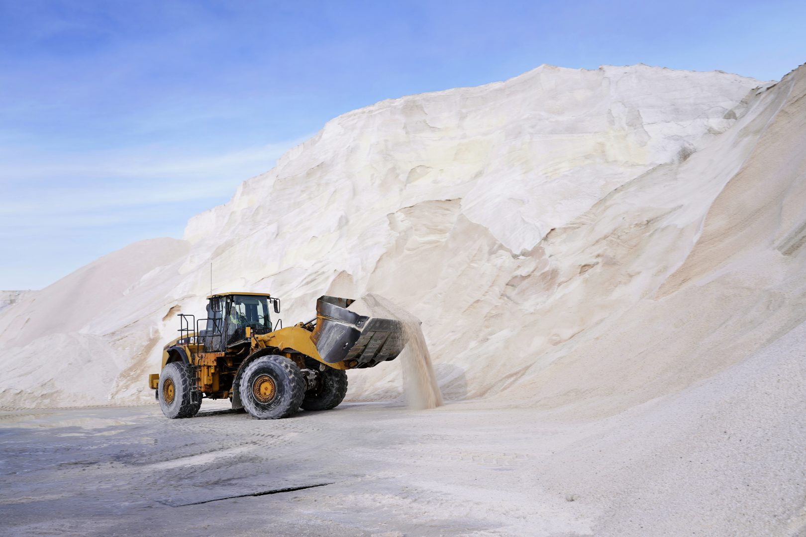 A front loader works at a large pile of road salt, Wednesday, Dec. 16, 2020, in Chelsea, Mass., as preparation continues for a storm that is expected to dump a foot or more of snow throughout the Northeast.