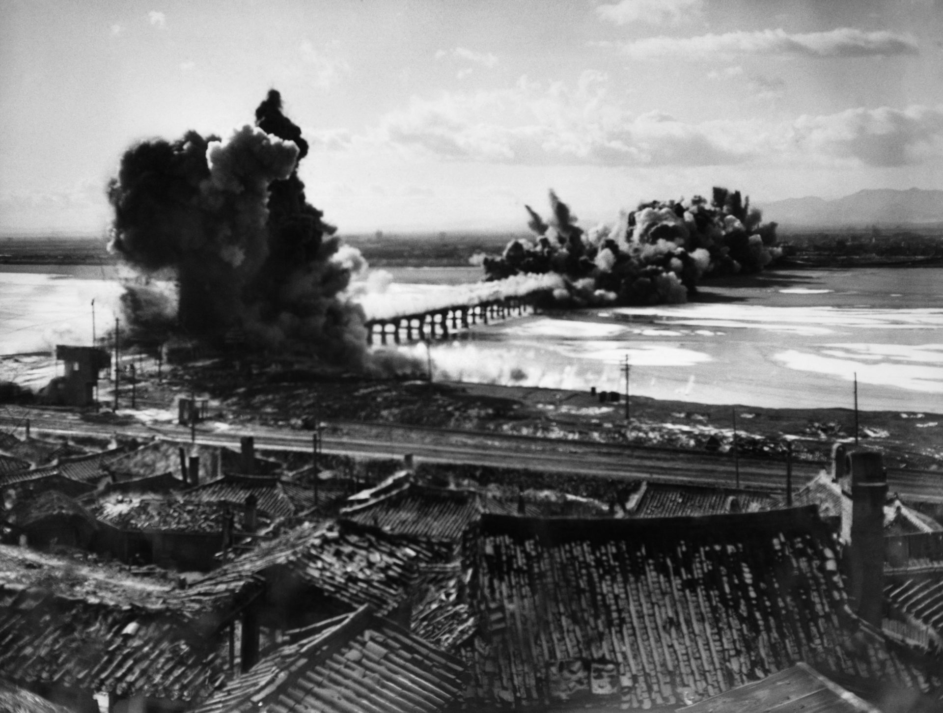 The Songchon River bridge into Hamhung is destroyed by demolition teams to slow the advance of Communist troops as United Nations troops evacuated the North Korean industrial city after the retreat from Chosin Reservoir.