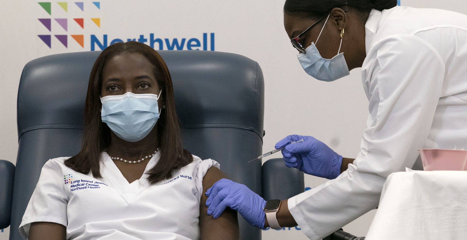 Sandra Lindsay, left, a nurse at Long Island Jewish Medical Center, is inoculated with the Pfizer-BioNTech COVID-19 vaccine by Dr. Michelle Chester, Monday, Dec. 14, 2020, in the Queens borough of New York.