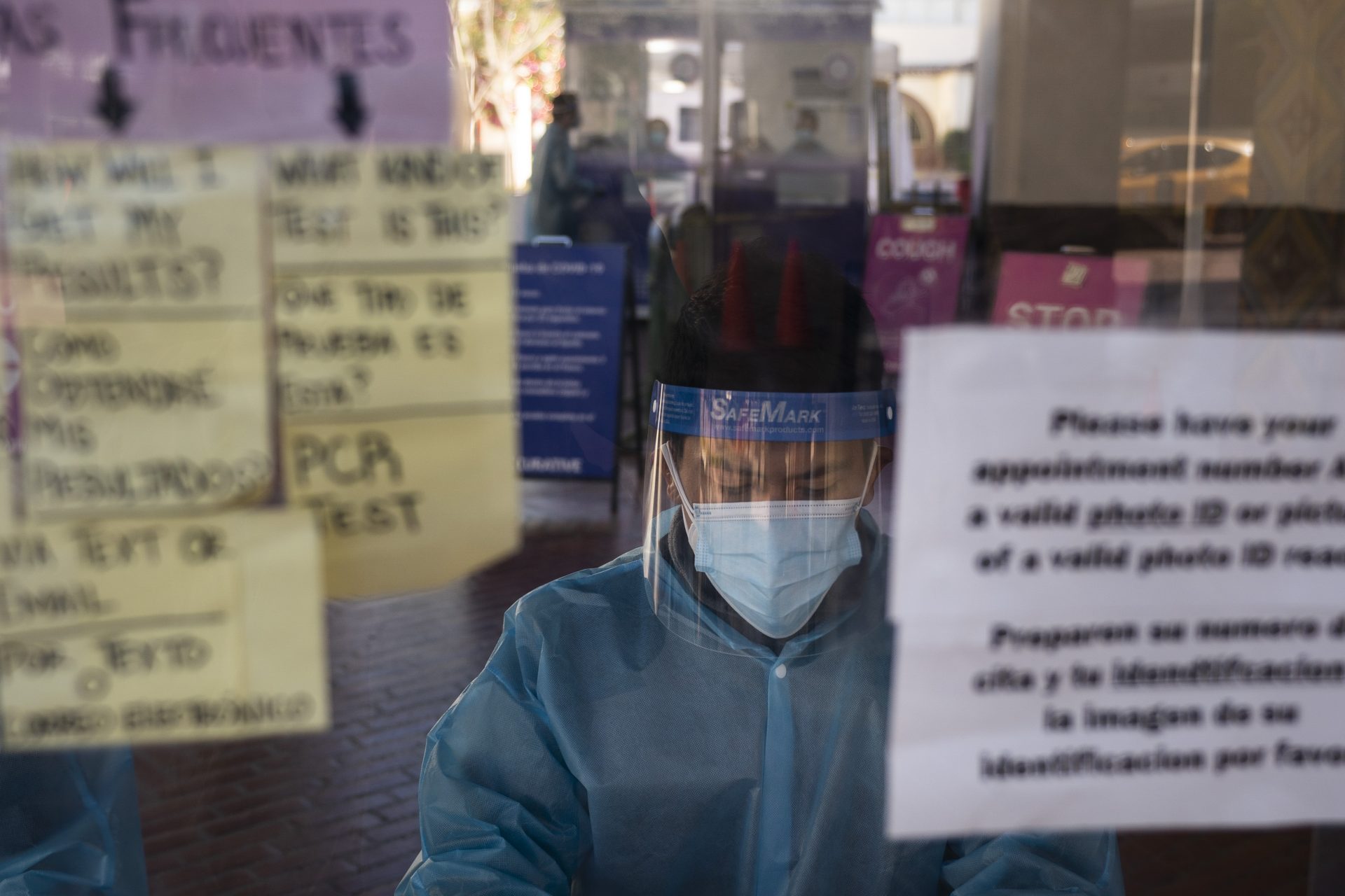 In this Dec. 9, 2020, file photo, test specialist Lester Gopar works at a COVID-19 testing site in Los Angeles. As officials met to discuss approval of a COVID-19 vaccine on Thursday, Dec. 10, the number of coronavirus deaths has grown bleaker than ever.