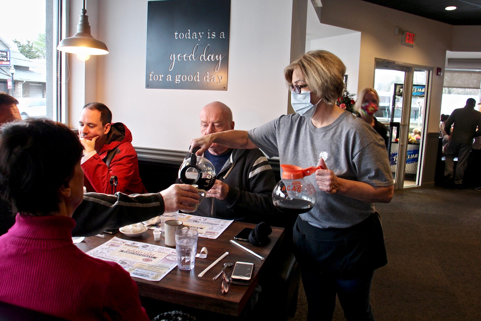 Laura Tierney, manager of Bonnet Lane Family Restaurant in Abington, Pa., serves customers in the dining room.