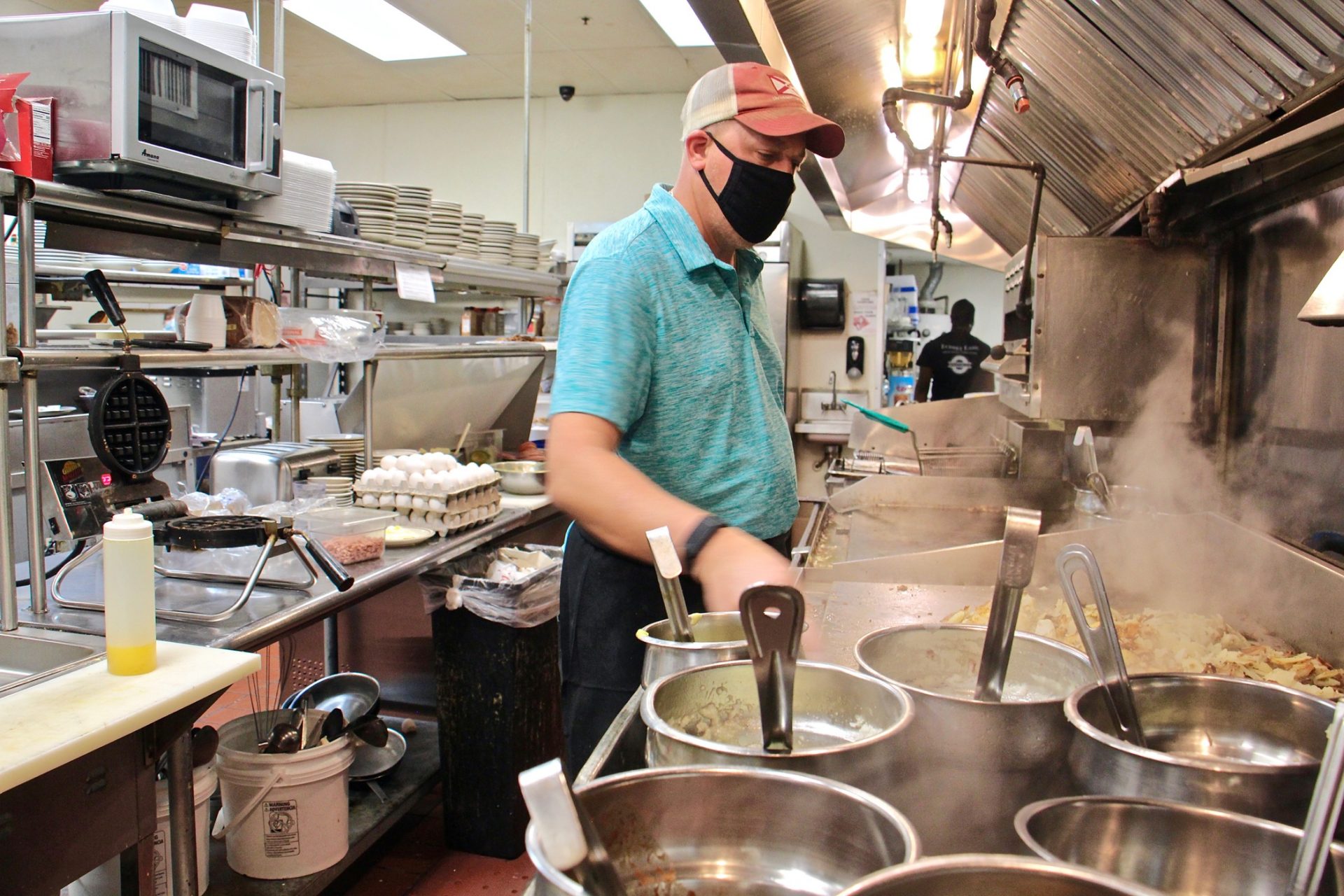 Mike Grafenstine works in the kitchen of his restaurant in Abington, Pa.