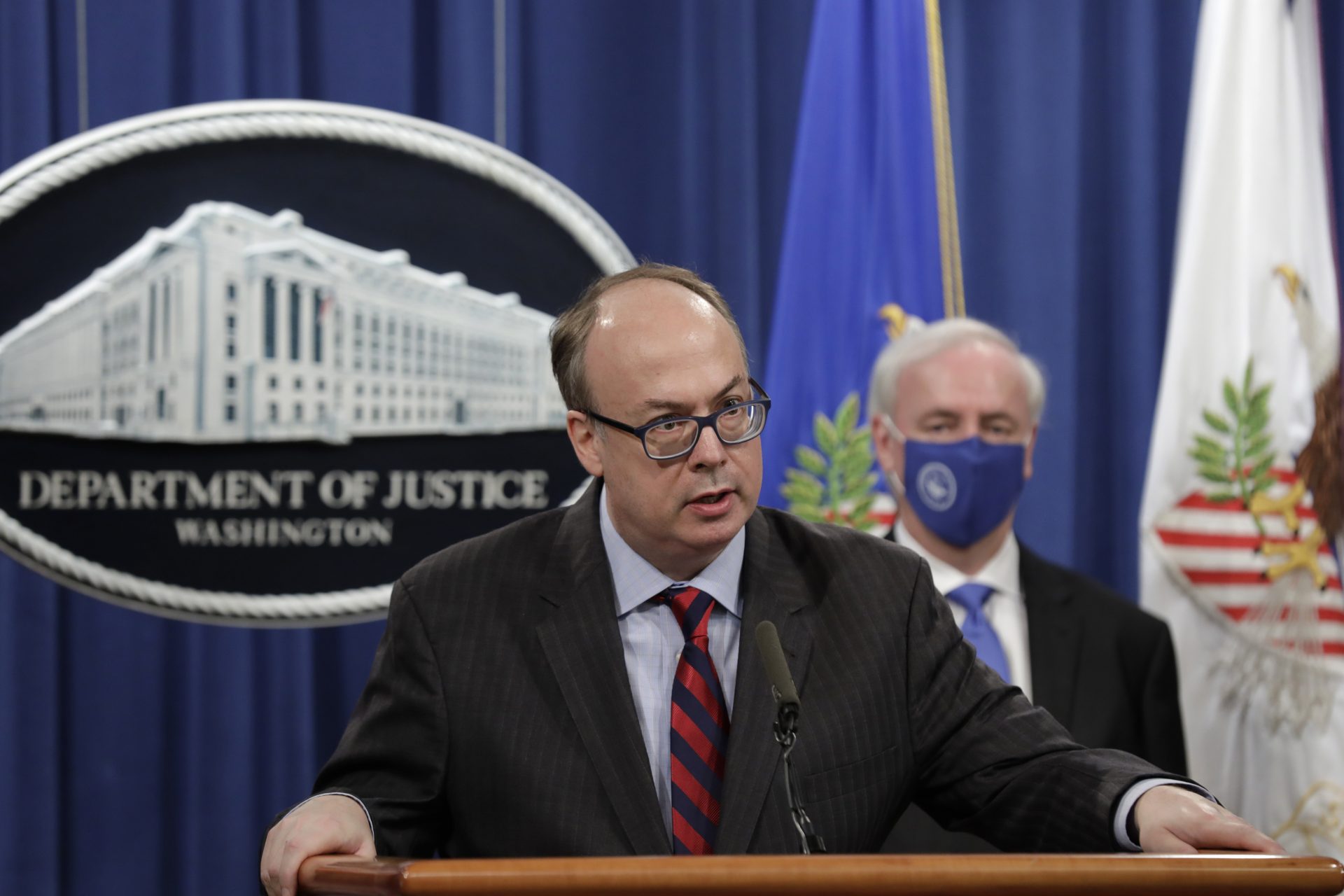 Acting Assistant U.S. Attorney General Jeffrey Clark speaks as he stands next to Deputy Attorney General Jeffrey A. Rosen during a news conference to announce the results of the global resolution of criminal and civil investigations with an opioid manufacturer at the Justice Department in Washington, Wednesday, Oct. 21, 2020.