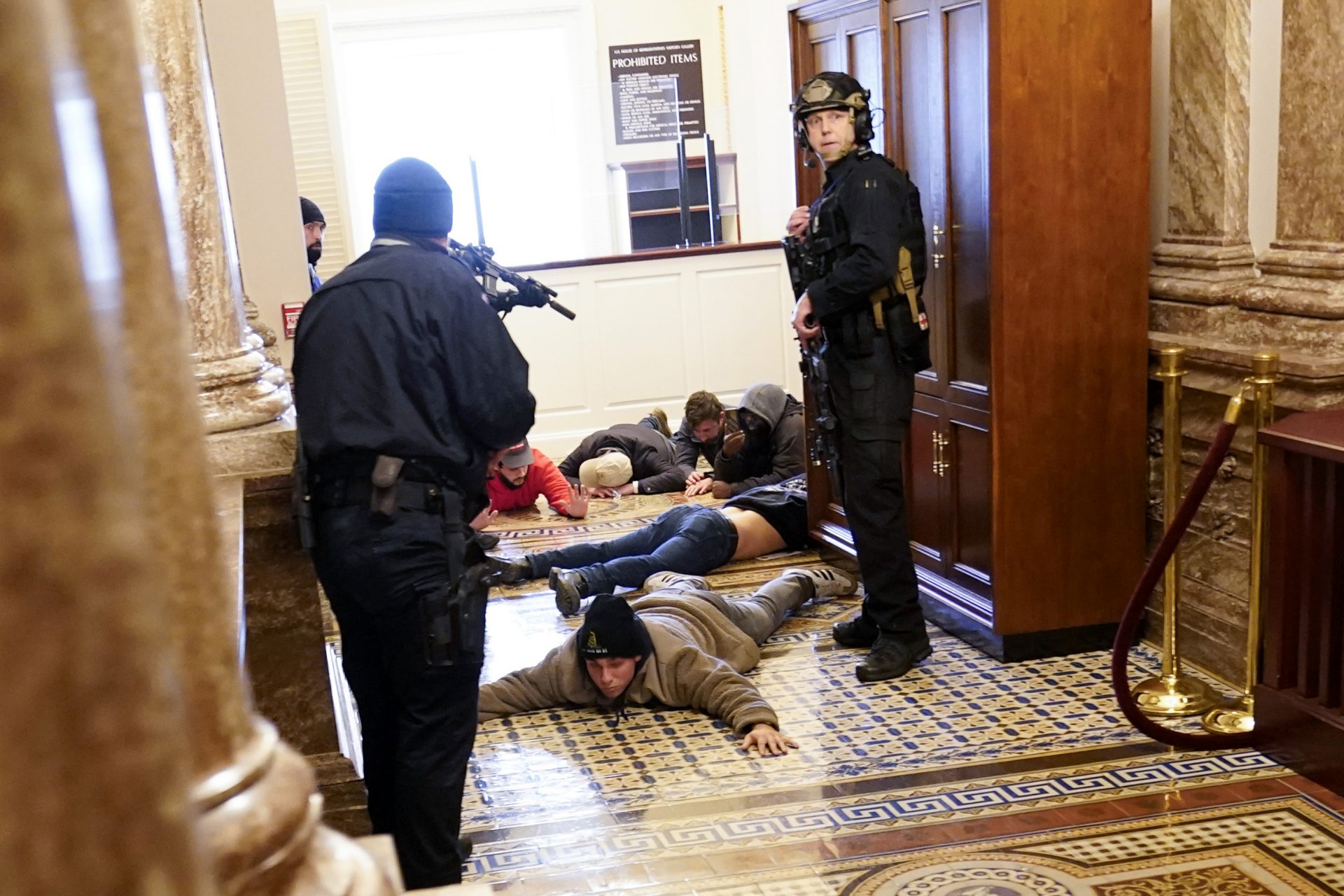 U.S. Capitol Police hold protesters at gun-point near the House Chamber inside the U.S. Capitol on Wednesday, Jan. 6, 2021, in Washington.