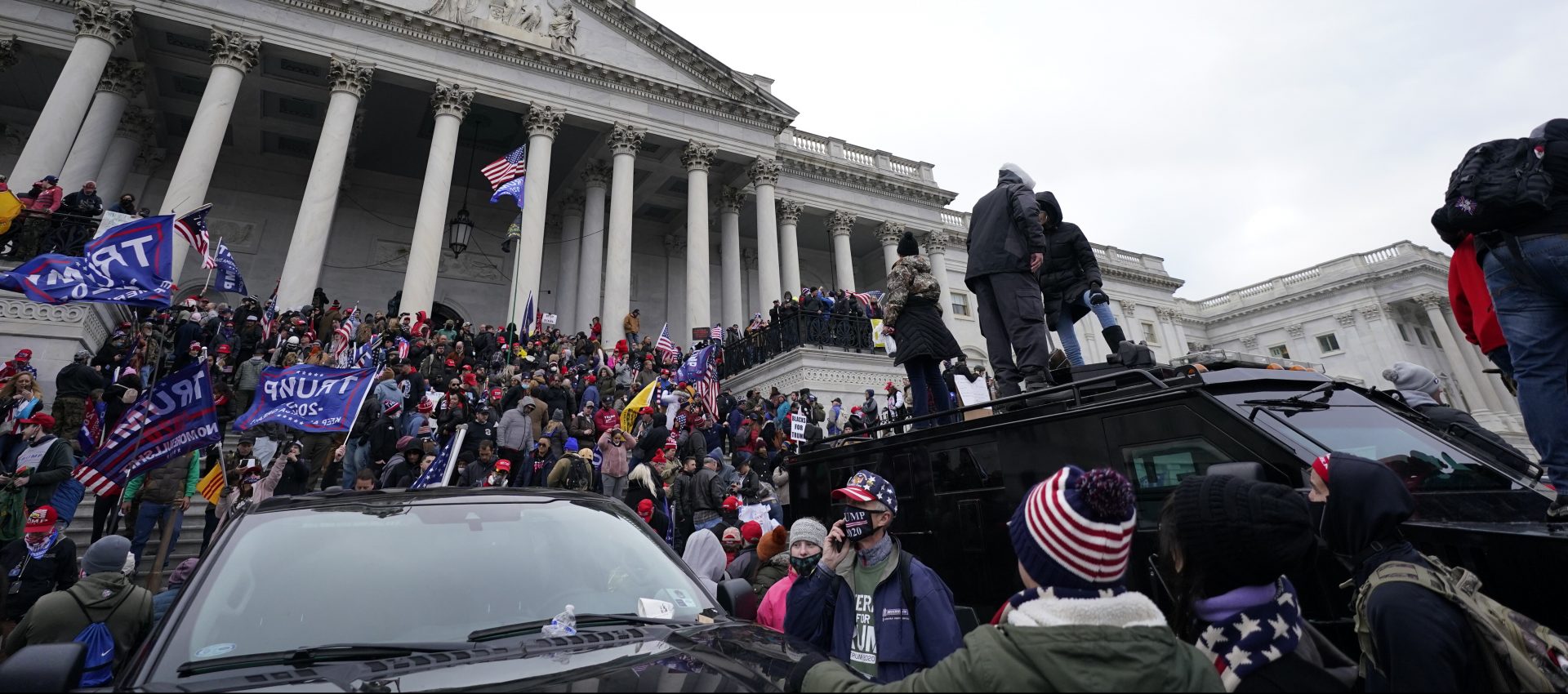 Trump supporters stand on top of a police vehicle, Wednesday, Jan. 6, 2021, at the Capitol in Washington. As Congress prepares to affirm President-elect Joe Biden's victory, thousands of people have gathered to show their support for President Donald Trump and his claims of election fraud.