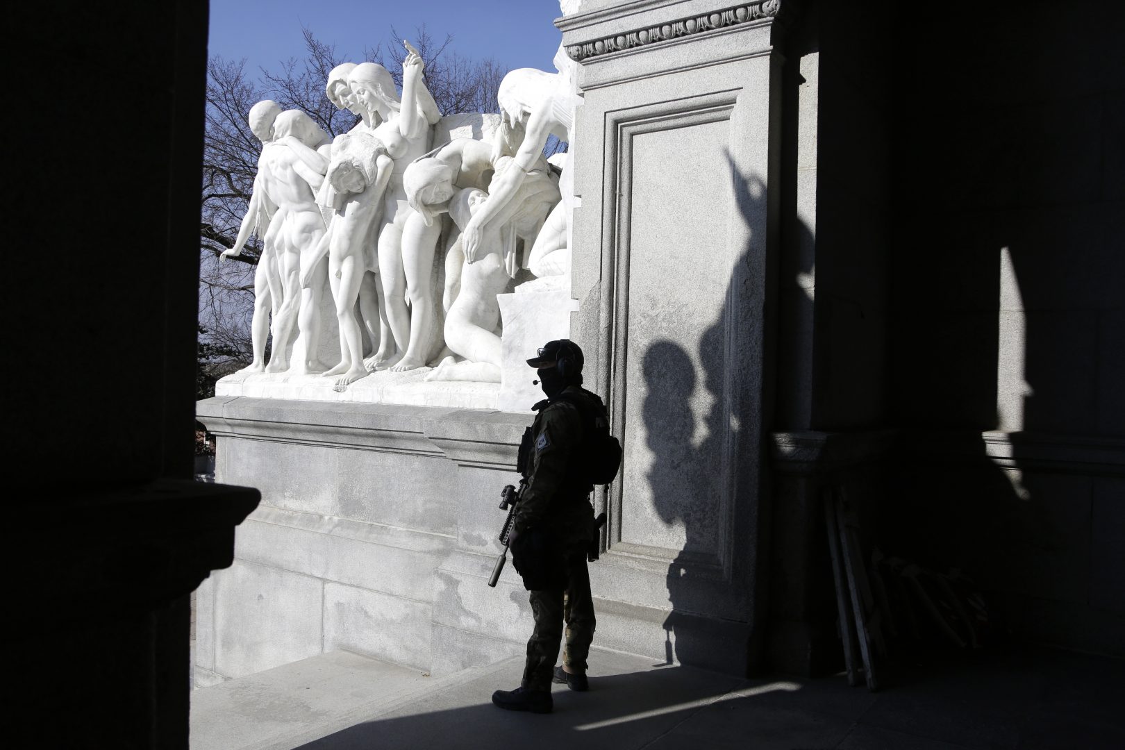 A Capitol police officer stands at the front entrance of the Pennsylvania Capitol building Tuesday Jan. 12, 2021,  in Harrisburg, Pa. State capitols across the country are under heightened security after the siege of the U.S. Capitol last week. 