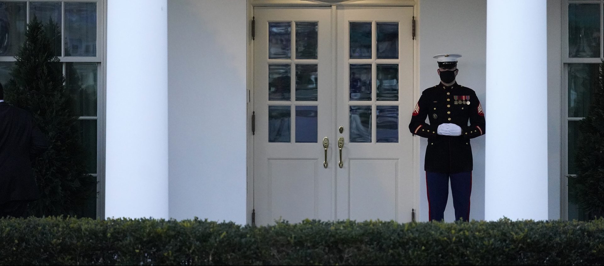 A Marine guard stands at the entrance to the West Wing of the White House, signifying that President Donald is in the Oval Office, while impeachment proceedings are going on in the U.S. Capitol against Trump in Washington, Tuesday, Jan. 12, 2021. The guard's presence usually indicates the president is in the Oval Office.