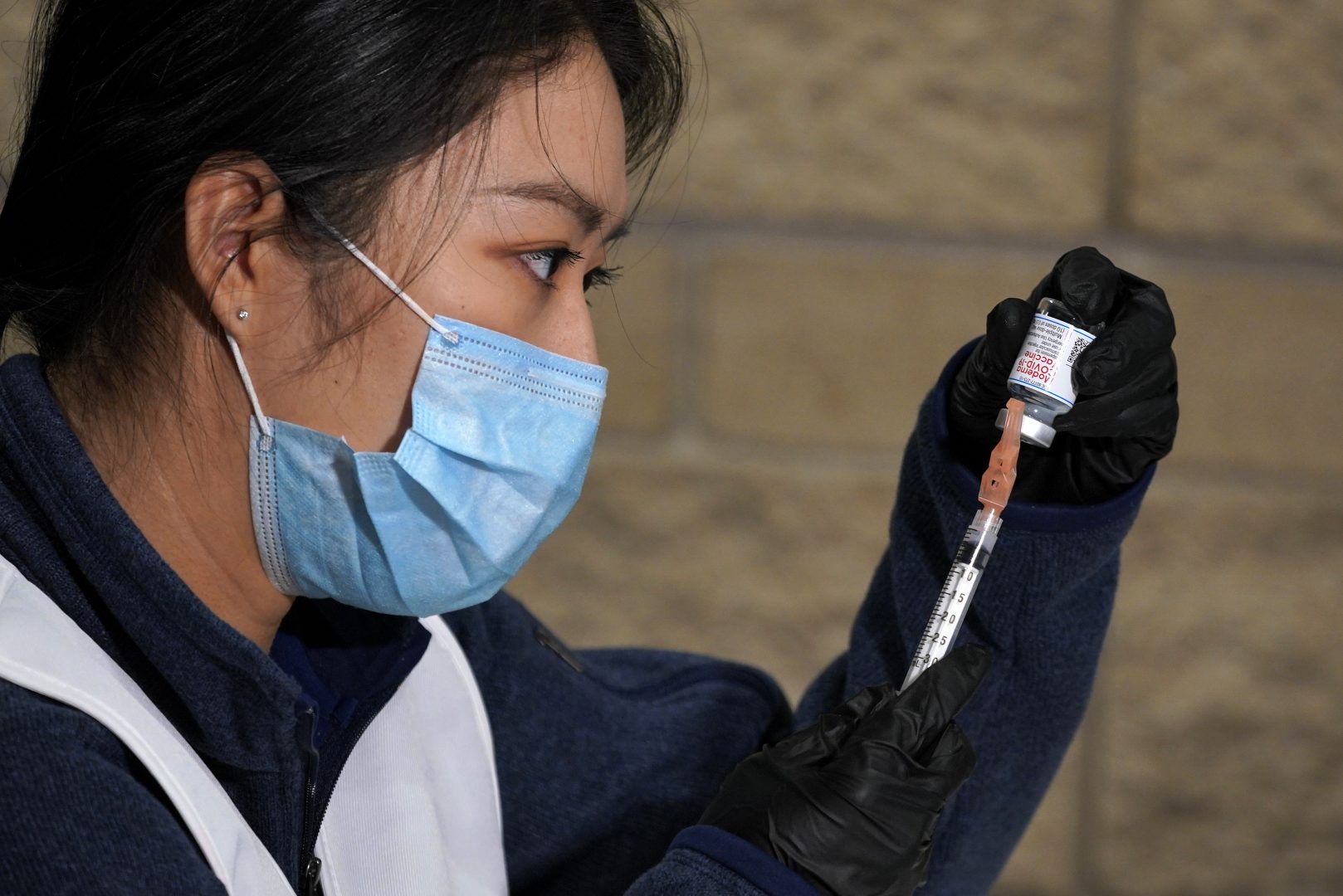 University of Pittsburgh Pharmacy student Edith Wang loads a syringe with a dose of the Moderna COVID-19 Vaccine, during a vaccination clinic hosted by the University of Pittsburgh and the Allegheny County Health Department at the Petersen Events Center, in Pittsburgh, Thursday, Jan. 28, 2021.