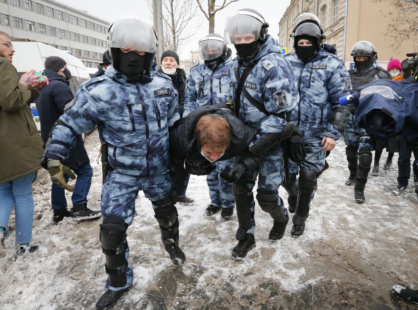 Police officers detain a man during a protest against the jailing of opposition leader Alexei Navalny in Moscow, Russia, on Sunday, Jan. 31, 2021. Thousands of people took to the streets Sunday across Russia to demand the release of jailed opposition leader Alexei Navalny, keeping up the wave of nationwide protests that have rattled the Kremlin. Hundreds were detained by police. (AP Photo/Alexander Zemlianichenko)