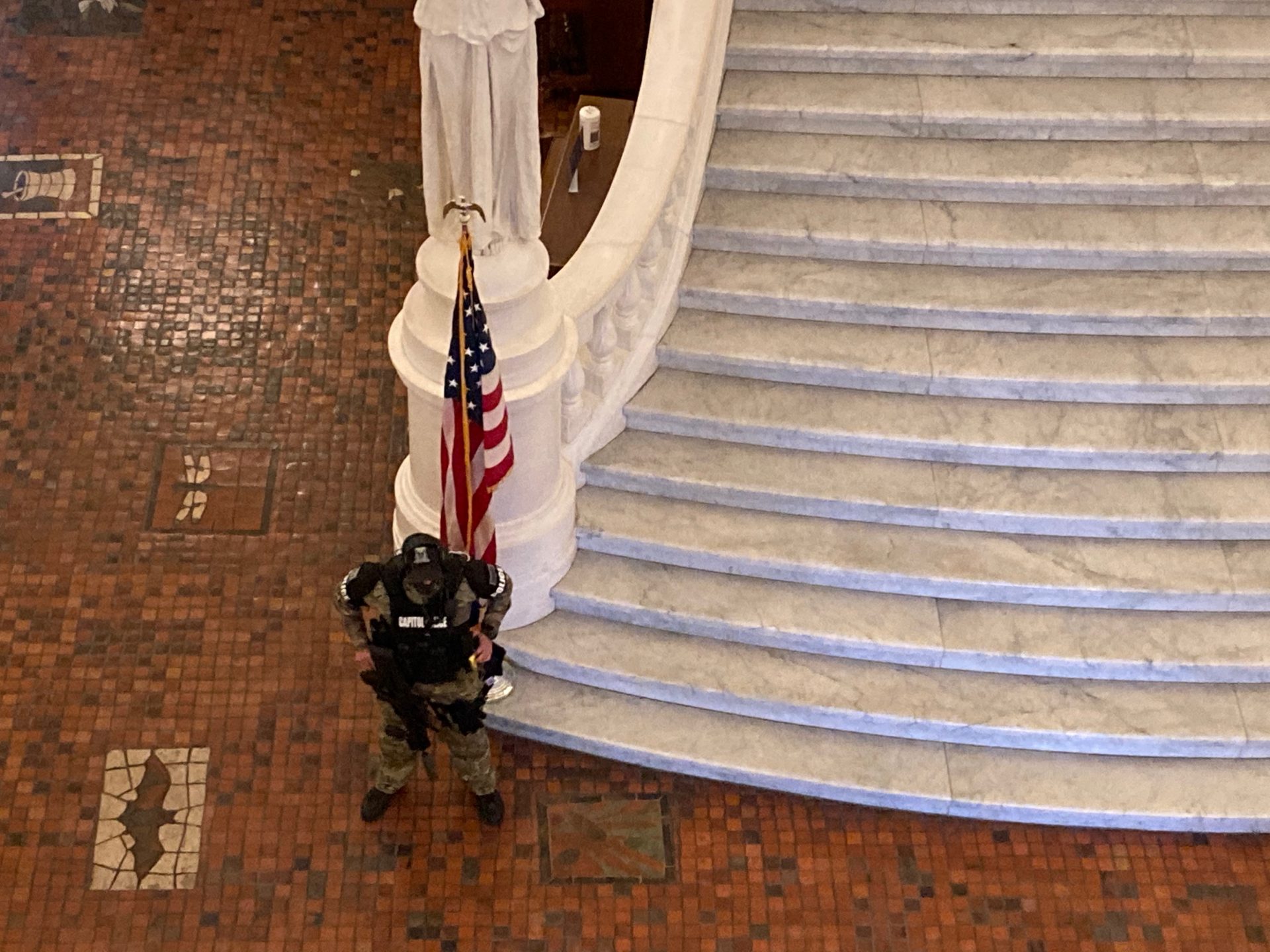 An armed Pennsylvania Capitol Police officer guards the rotunda at the Pennsylvania Capitol on Jan. 12, 2021.