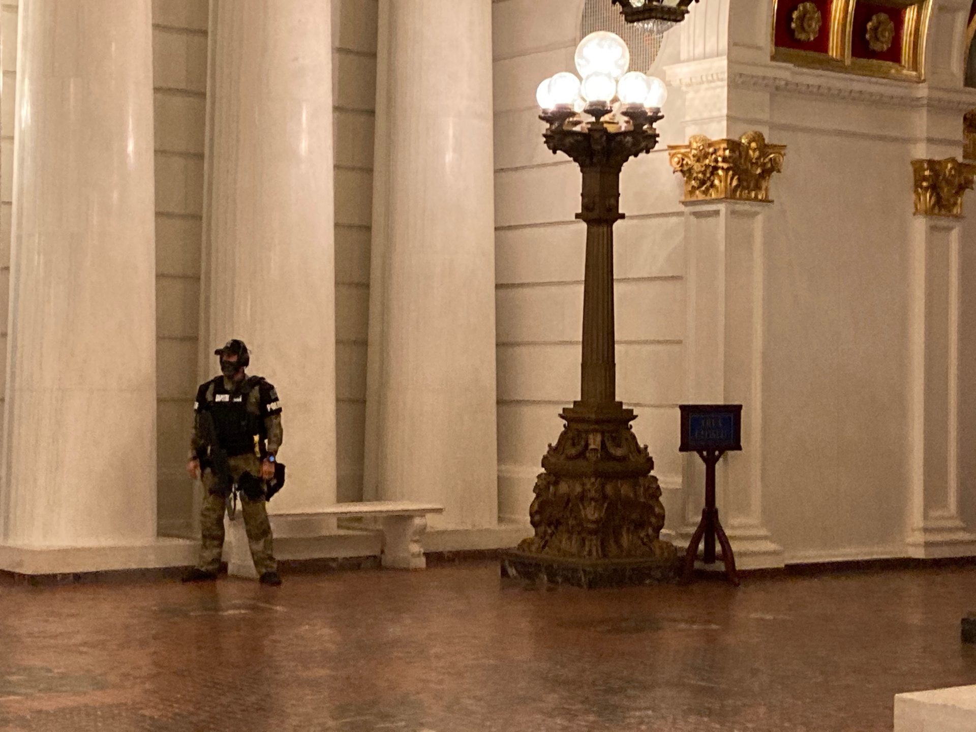 An armed Pennsylvania Capitol Police officer guards the building on Jan. 12, 2021.