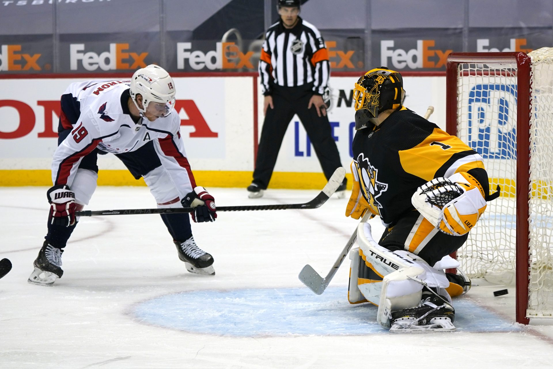 Washington Capitals' Nicklas Backstrom (19) puts the puck behind Pittsburgh Penguins goaltender Casey DeSmith for a goal during the second period of an NHL hockey game in Pittsburgh, Sunday, Jan. 17, 2021.