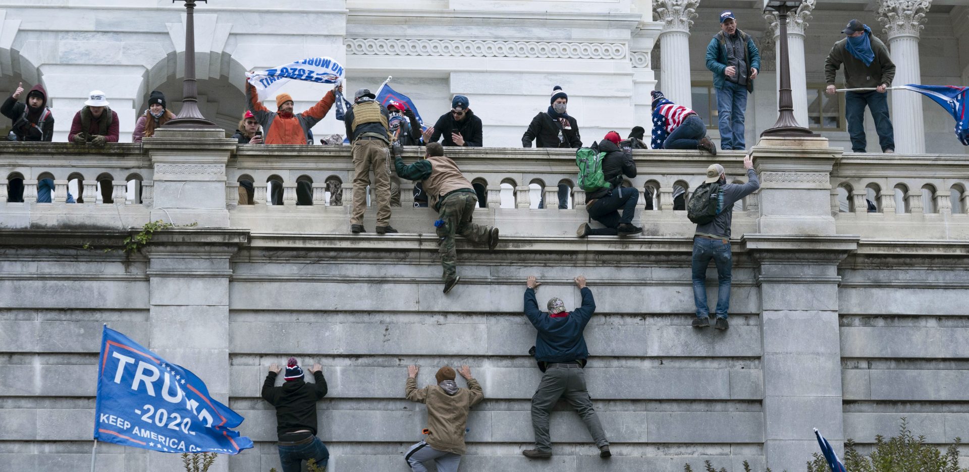 Supporters of President Donald Trump climb the west wall of the the U.S. Capitol on Wednesday, Jan. 6, 2021, in Washington.