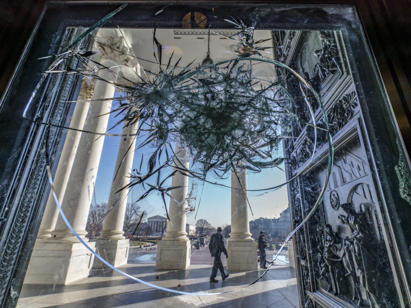 Shattered glass from last week's attack on Congress by a pro-Trump mob is seen in the doors leading to the Capitol Rotunda, in Washington, Tuesday, Jan. 12, 2021. 