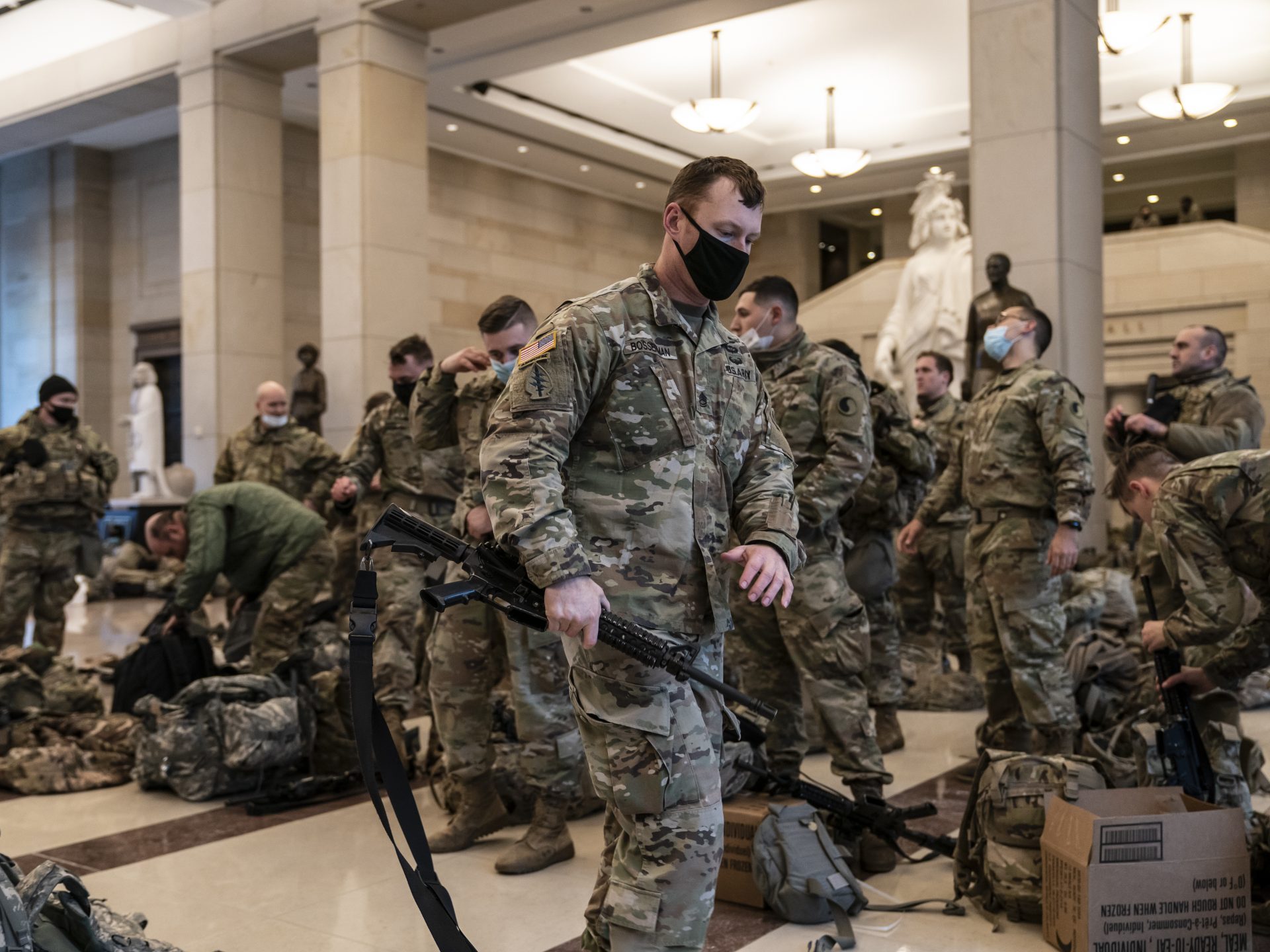 Hundreds of National Guard troops hold inside the Capitol Visitor's Center to reinforce security at the Capitol in Washington on Wednesday. It comes a week after an insurrection at the Capitol and as the House of Representatives is pursuing an article of impeachment against President Trump.