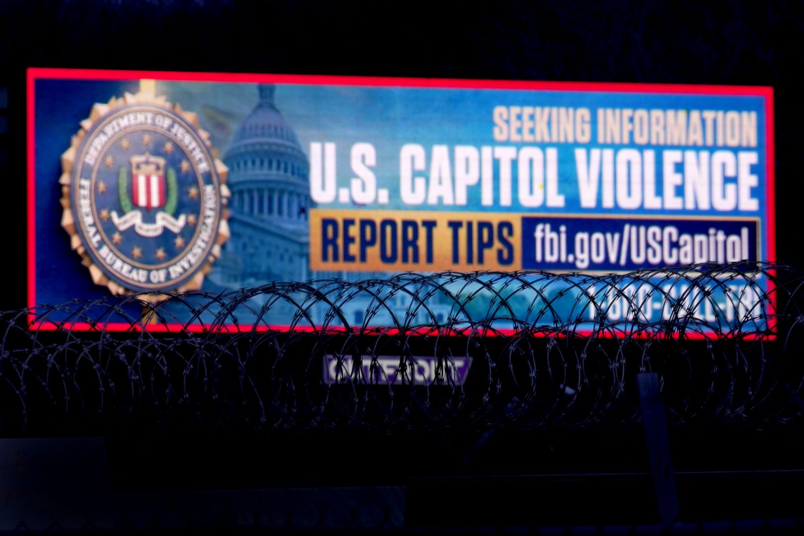 A billboard seeking tips about rioters who breached the United States Capitol Building on Jan. 6 stands along Interstate 35 Saturday, Jan. 16, 2021, in Kansas City, Kan.