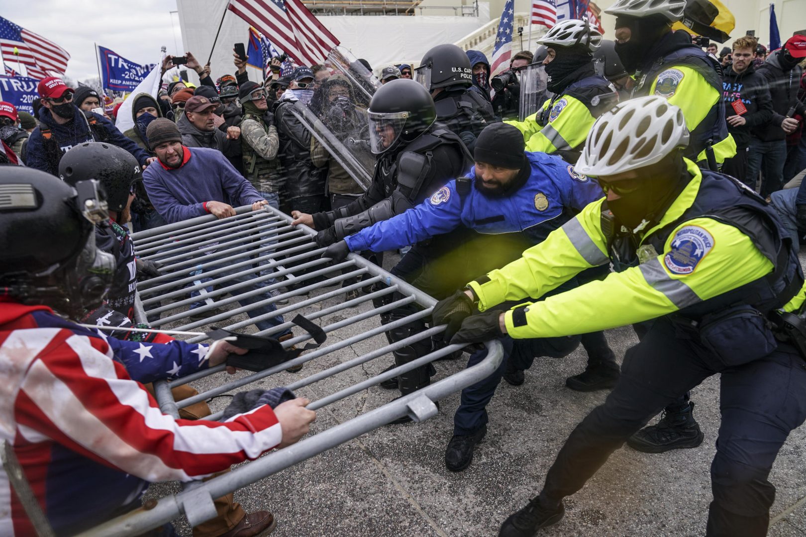 FILE - In this Jan. 6, 2021, file photo rioters try to break through a police barrier at the Capitol in Washington.