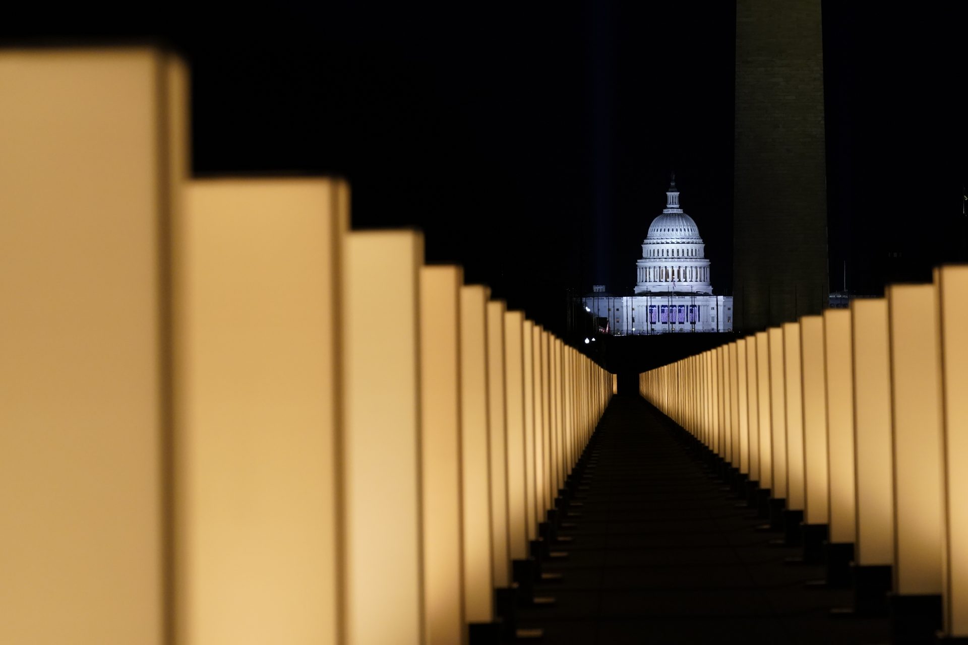 Lights surround the Lincoln Memorial Reflecting Pool, placed as a memorial to COVID-19 victims Tuesday, Jan. 19, 2021, in Washington, after President-elect Joe Biden spoke, with the U.S. Capitol in the background.