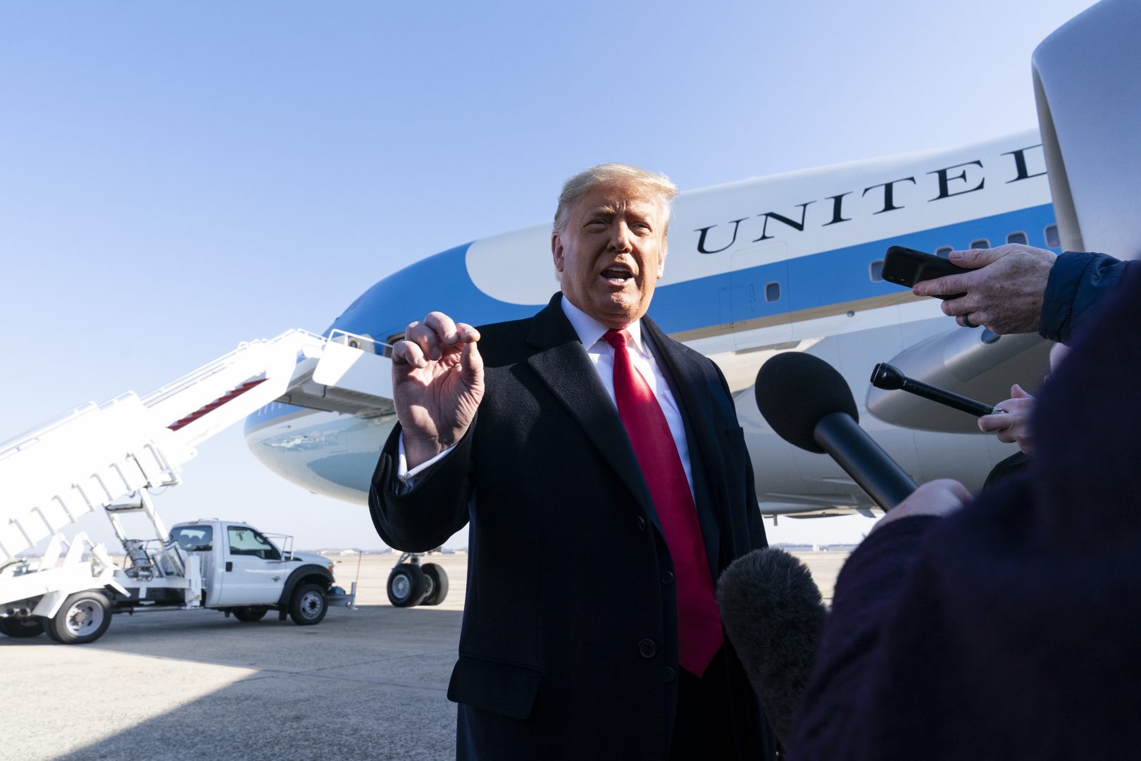 President Donald Trump speaks with reporters before boarding Air Force One upon departure, Tuesday, Jan. 12, 2021, at Andrews Air Force Base, Md.