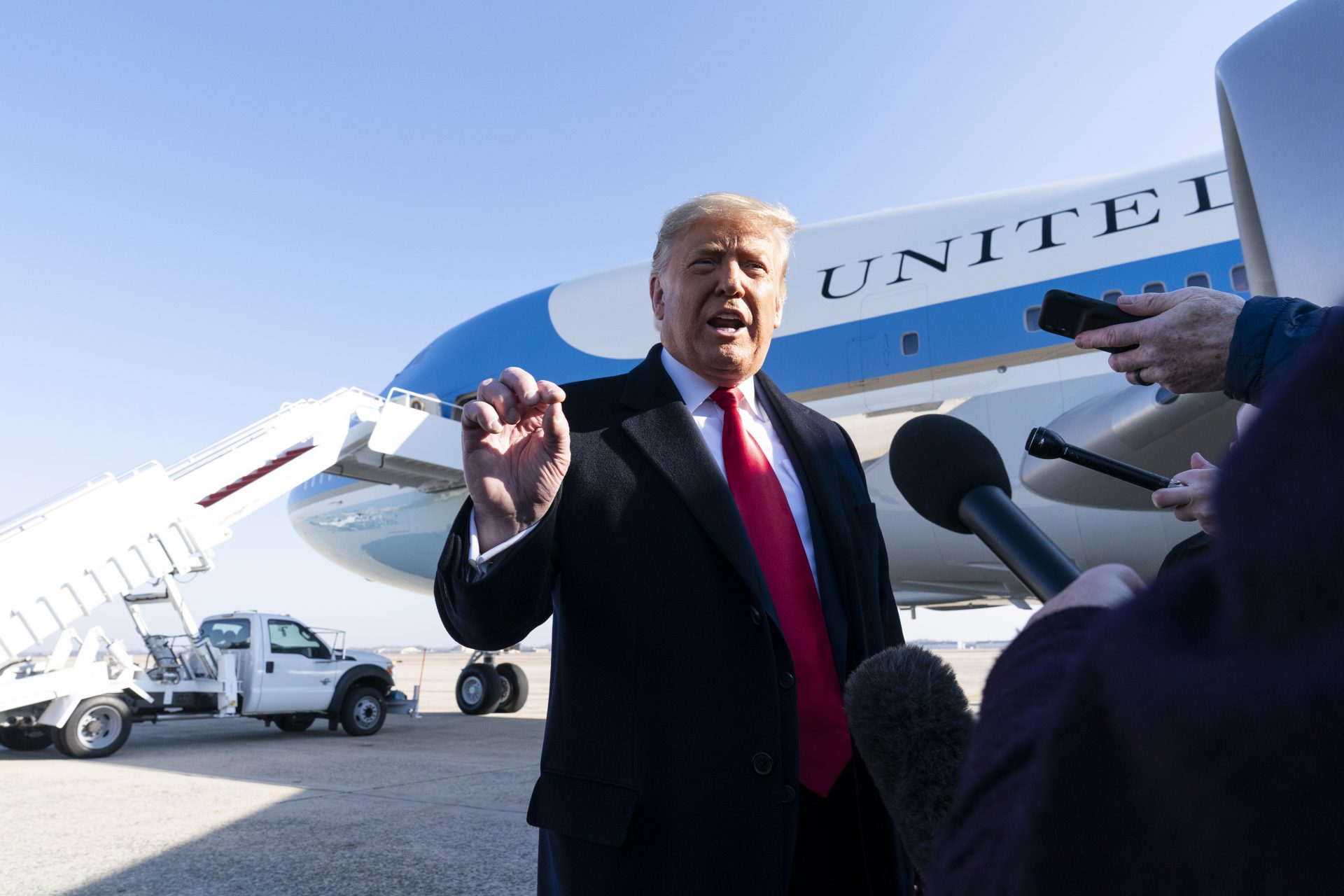 President Donald Trump speaks with reporters before boarding Air Force One upon departure, Tuesday, Jan. 12, 2021, at Andrews Air Force Base, Md. The President is traveling to Texas.
