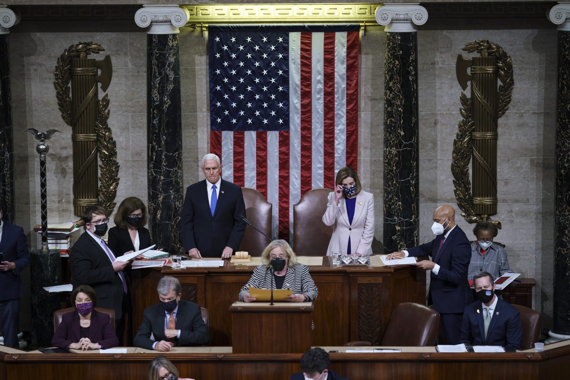 Vice President Mike Pence and Speaker of the House Nancy Pelosi, D-Calif., prepare to read the final certification of Electoral College votes cast in November's presidential election during a joint session of Congress after working through the night, at the Capitol in Washington, Thursday, Jan. 7, 2021. Violent protesters loyal to President Donald Trump stormed the Capitol Wednesday, disrupting the process.