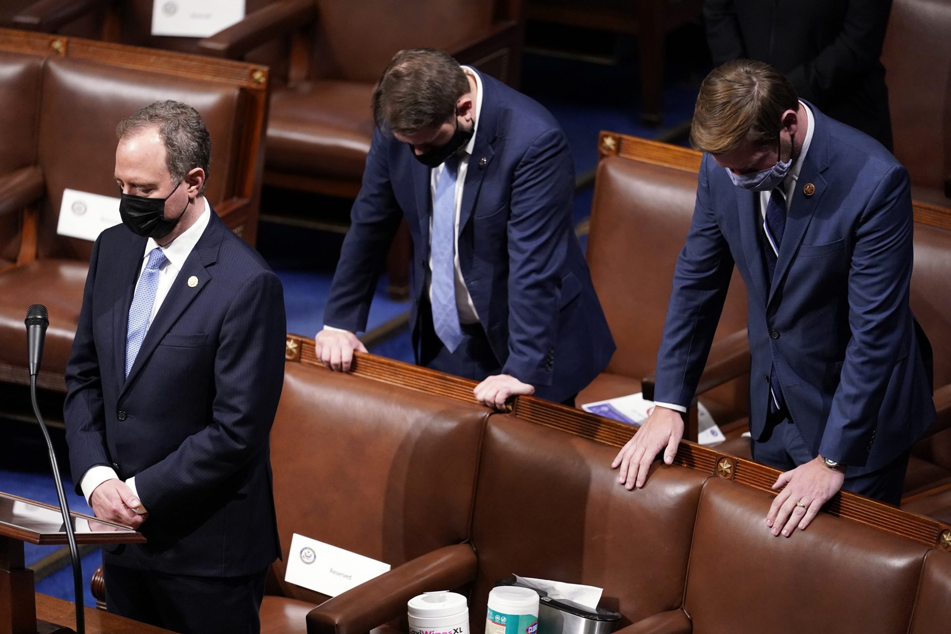 Rep. Adam Schiff, D-Calif., left, bows his head during a closing prayer of a joint session of the House and Senate to confirm Electoral College votes at the Capitol, early Thursday, Jan 7, 2021, in Washington.