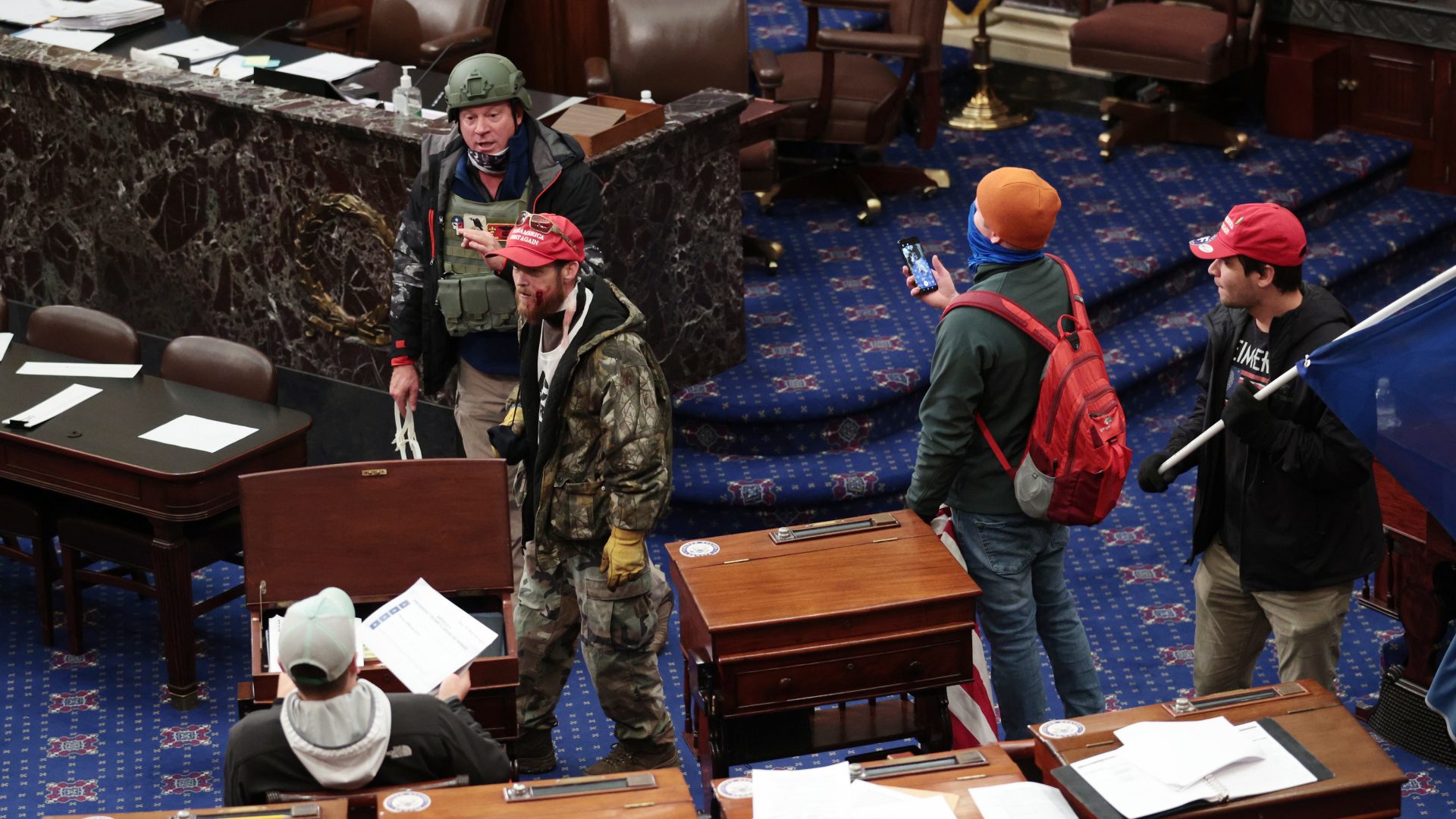 Larry Rendall Brock Jr., an Air Force veteran, is seen inside the Senate Chamber wearing a military-style helmet and tactical vest during the rioting at the U.S. Capitol. Federal prosecutors have alleged that in the months ahead of the attack, Brock posted on Facebook about an impending "Second Civil War."