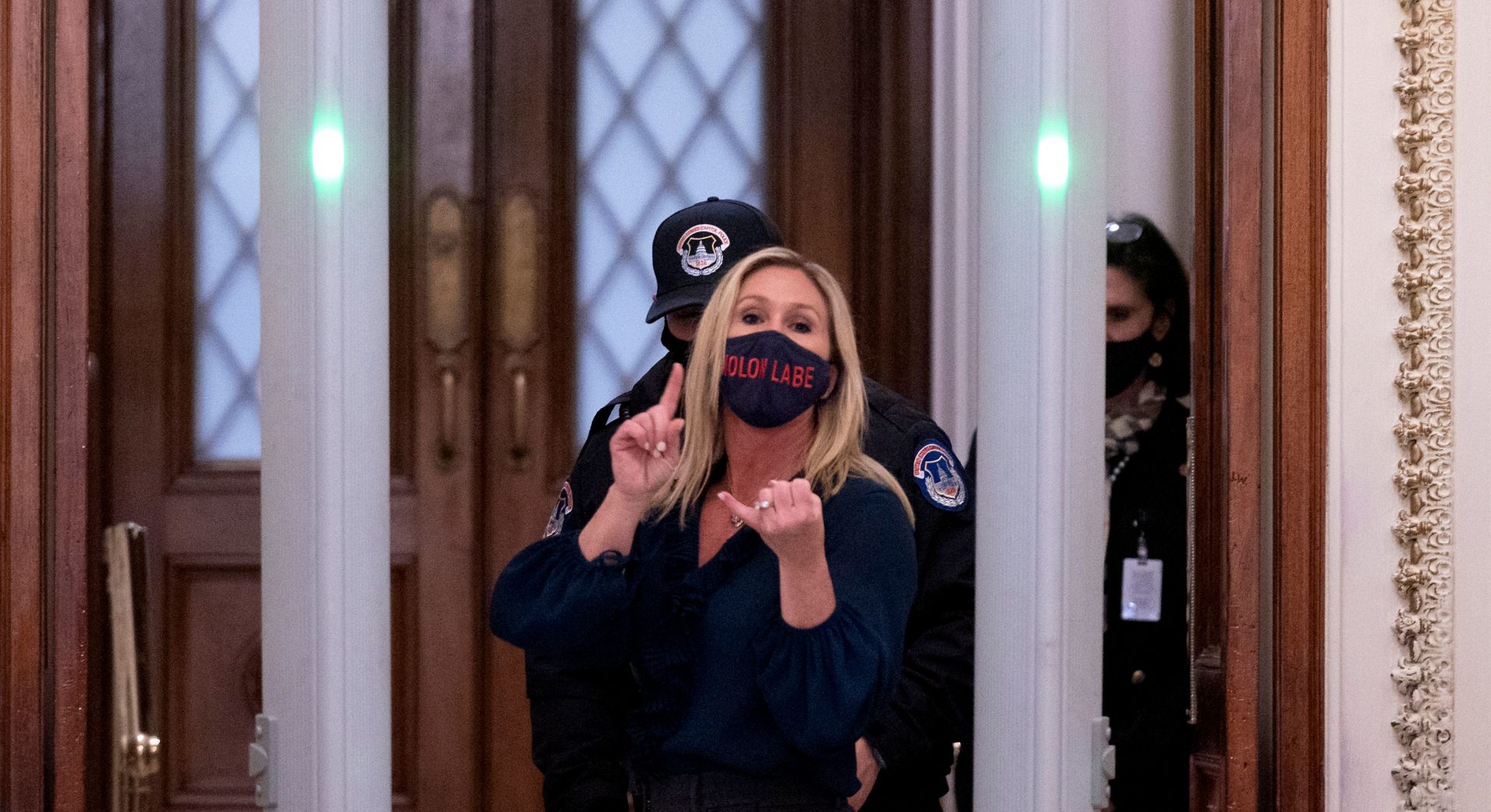 Republican Rep. Marjorie Taylor Greene of Georgia shouts at journalists as she goes through security outside the House Chamber at Capitol Hill.