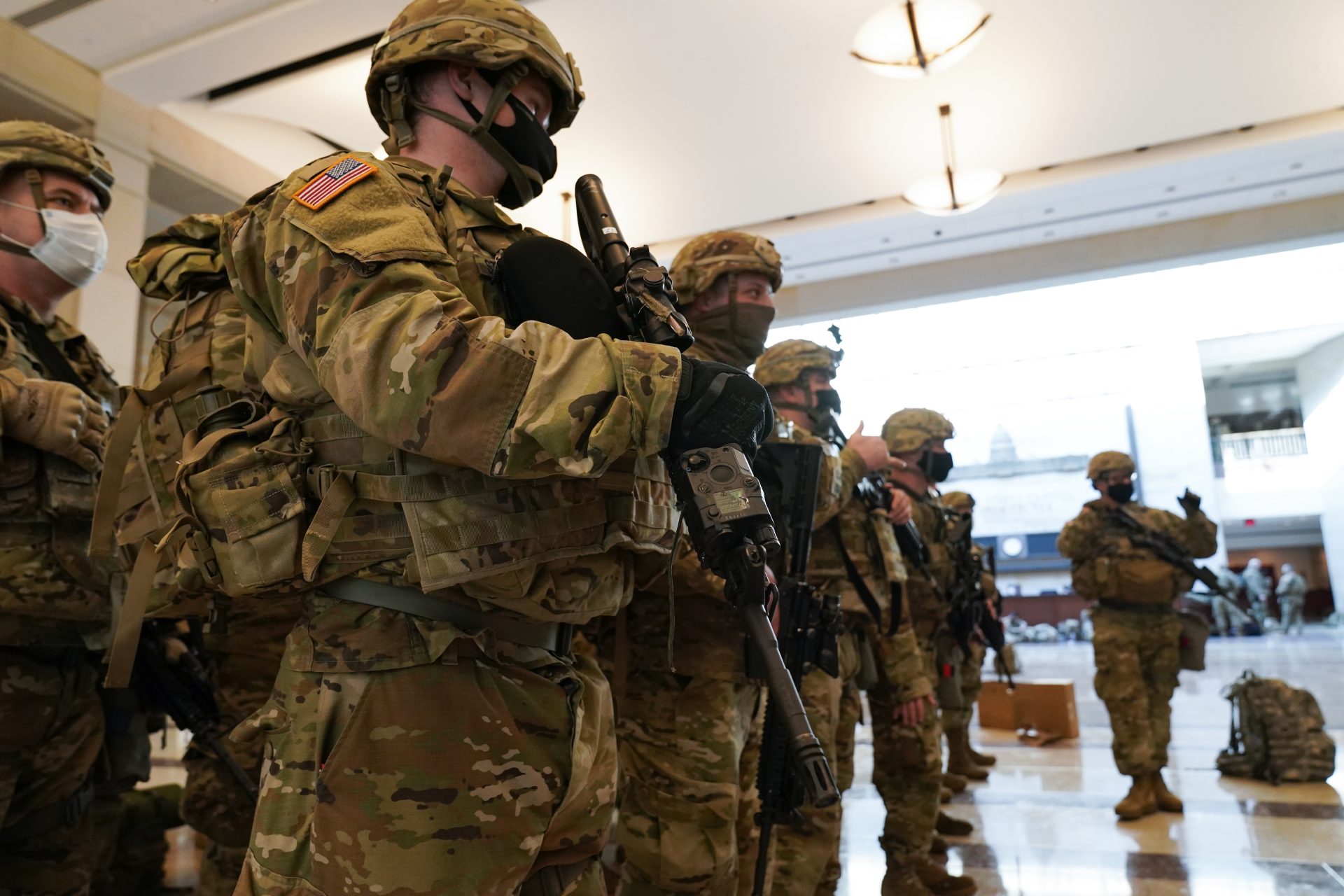Troops stand in formation inside the Capitol Visitor's Center to reinforce security at the Capitol in Washington, Wednesday, Jan. 13, 2021. The House of Representatives is pursuing an article of impeachment against President Donald Trump for his role in inciting an angry mob to storm the Capitol last week.