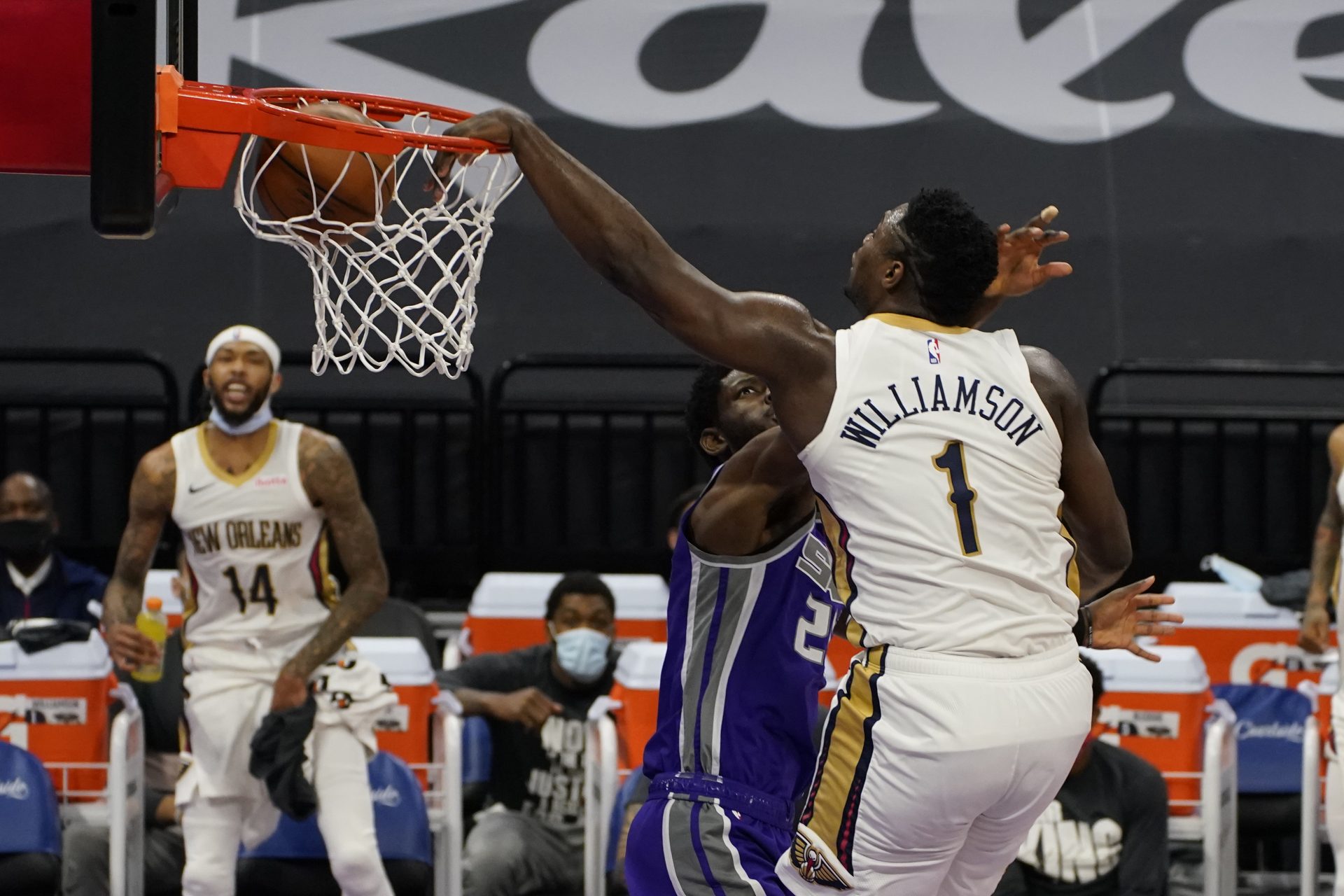 New Orleans Pelicans forward Zion Williamson, right, dunks over Sacramento Kings forward Chimezie Metu during the first quarter of an NBA basketball game in Sacramento, Calif., Sunday, Jan.17, 2021.