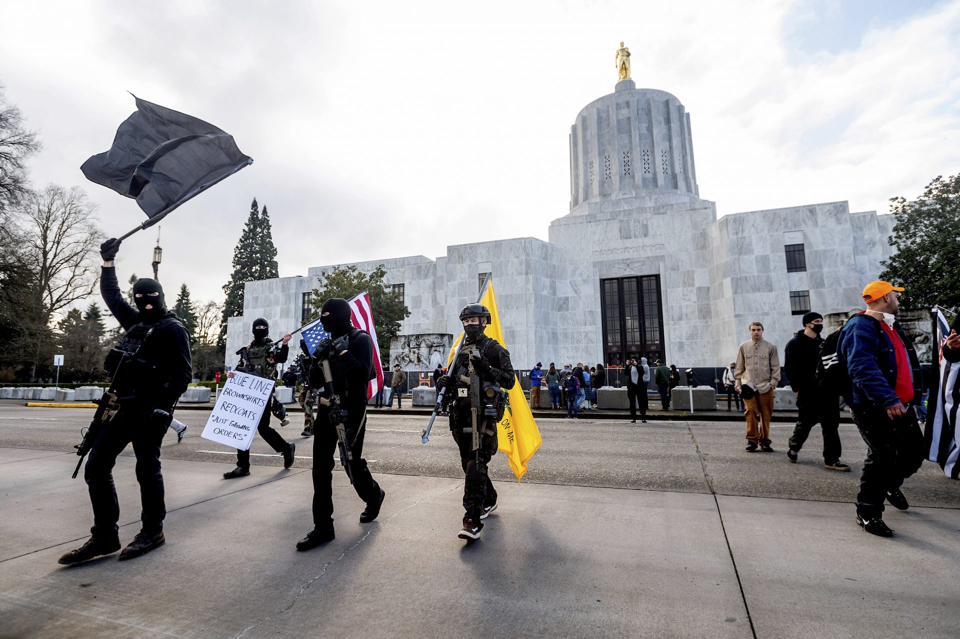 Protesters who identified themselves as Liberty Boys gather outside the Oregon State Capitol on Sunday, Jan. 17, 2021, in Salem, Ore. The group said they want reduced government and do not support President Donald Trump or President-elect Joe Biden.