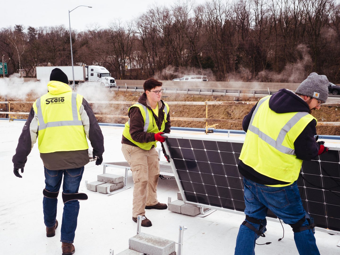 Workers install solar panels on the roof of Global Links, a medical relief nonprofit, in Green Tree, Pa., on Wednesday, Feb. 5, 2020.
