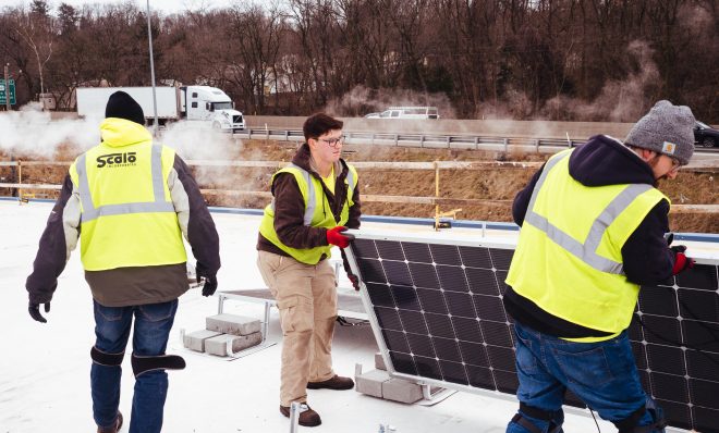 Workers install solar panels on the roof of Global Links, a medical relief nonprofit, in Green Tree, Pa., on Wednesday, Feb. 5, 2020.