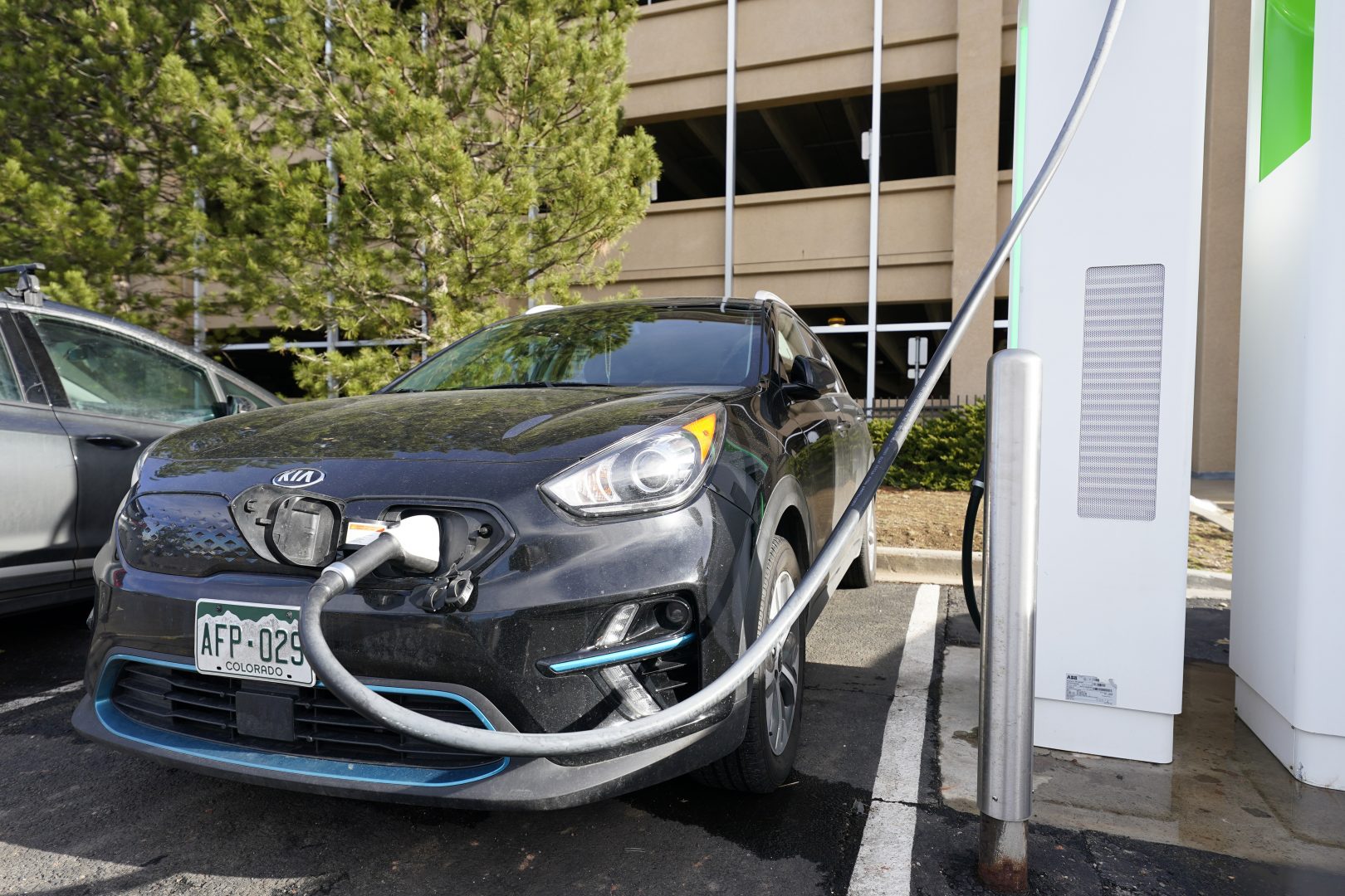A Kia Niro EV is charged at a charging station at Colorado Mills Outlet Mall Monday, Dec. 21, 2020, in Lakewood, Colo.