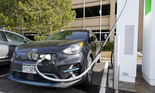 A Kia Niro EV is charged at a charging station at Colorado Mills Outlet Mall Monday, Dec. 21, 2020, in Lakewood, Colo.