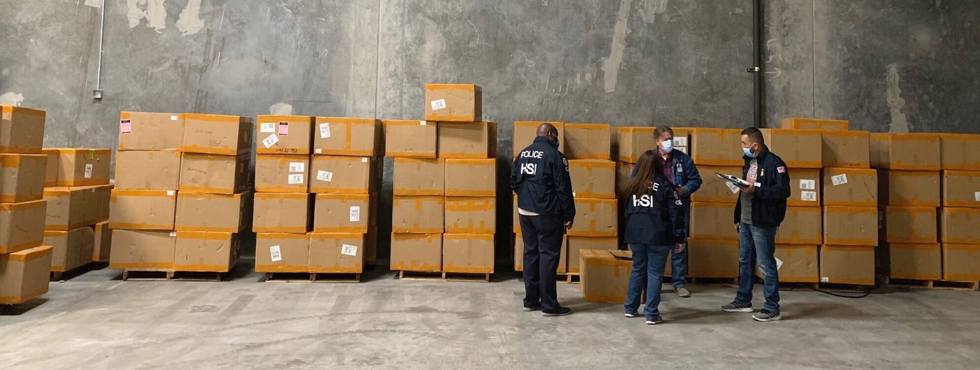 This December 2020, image provided by U.S. Immigration and Customs Enforcement (ICE) shows Homeland Security Investigations El Paso members and U.S. Customs and Border Protection officers working during a seizure of counterfeit N95 surgical masks at an El Paso Port cargo facility in El Paso, Texas. Federal investigators are probing a massive counterfeit N95 mask operation sold in at least five states to hospitals, medical facilities, and government agencies. The fake 3M masks are at best a copyright violations and at worst unsafe fakes that put unknowing health care workers at grave risk for coronavirus. And they are becoming increasingly difficult to spot.